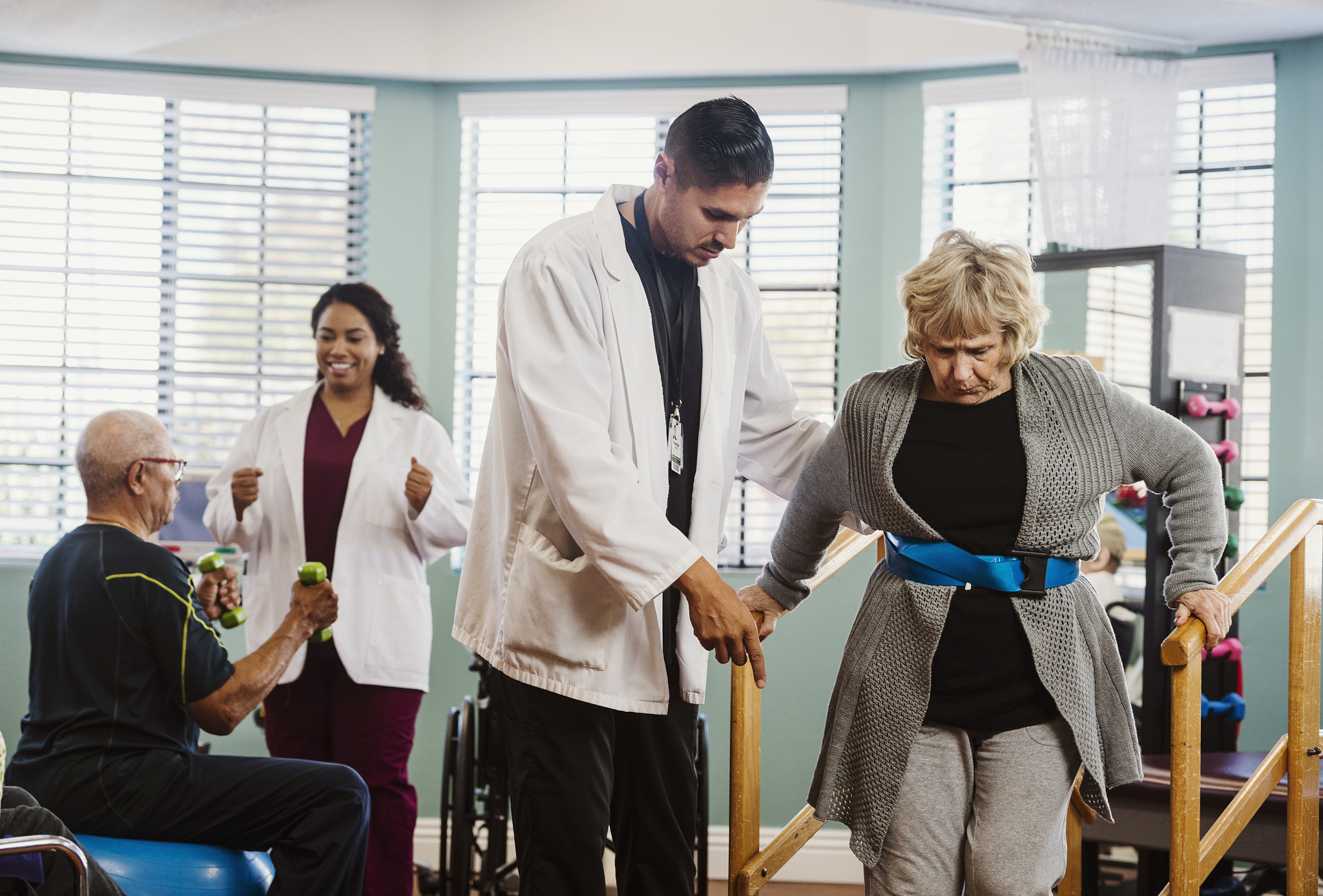 senior people exercising with therapists during physical therapy