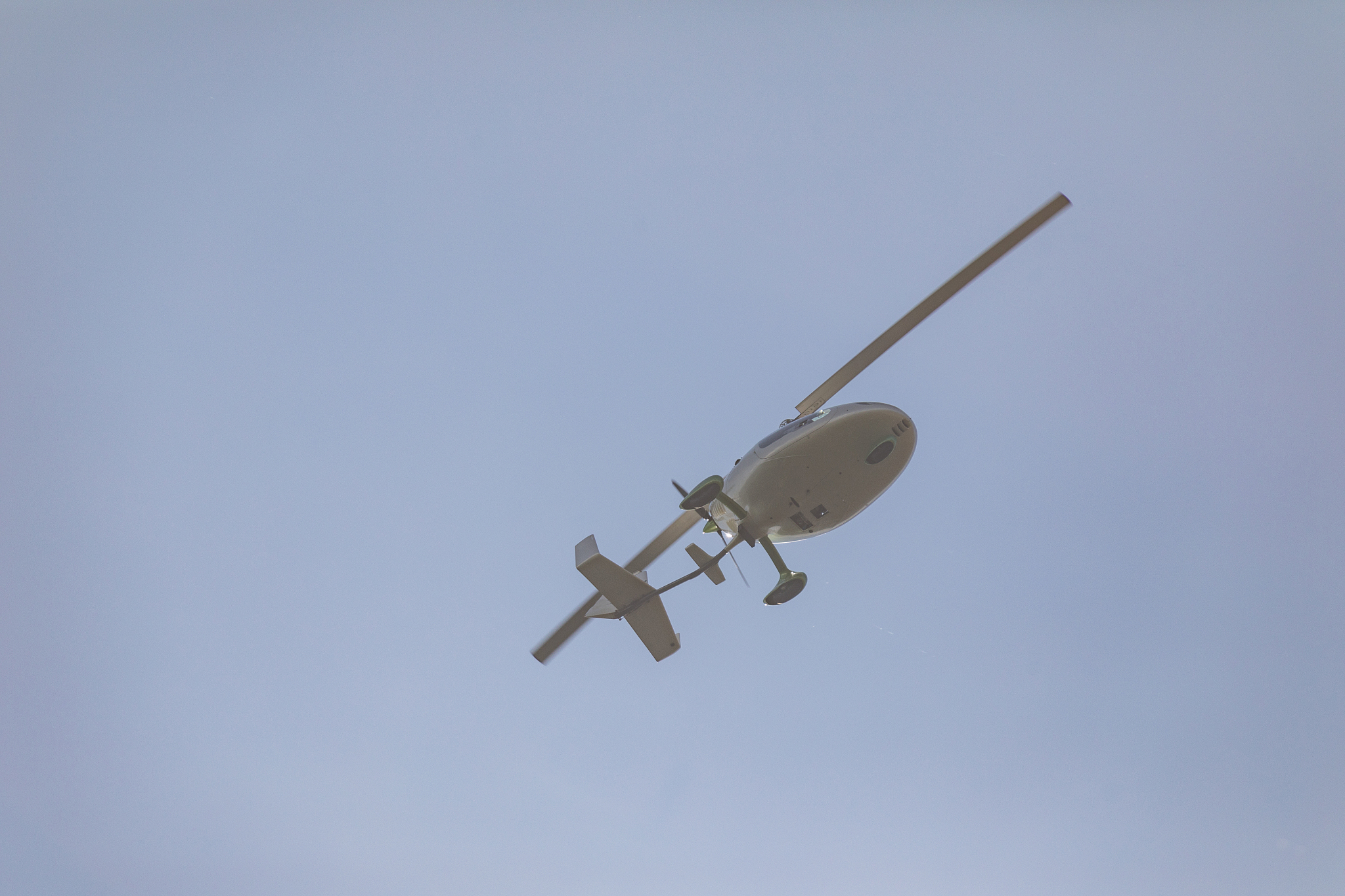white gyroplane in sky