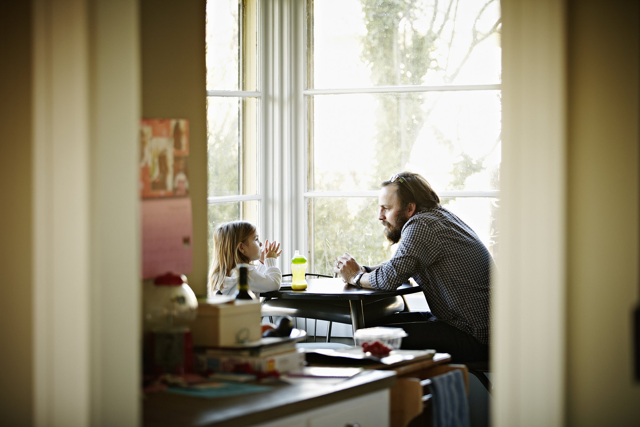 father and daughter sitting at table in discussion
