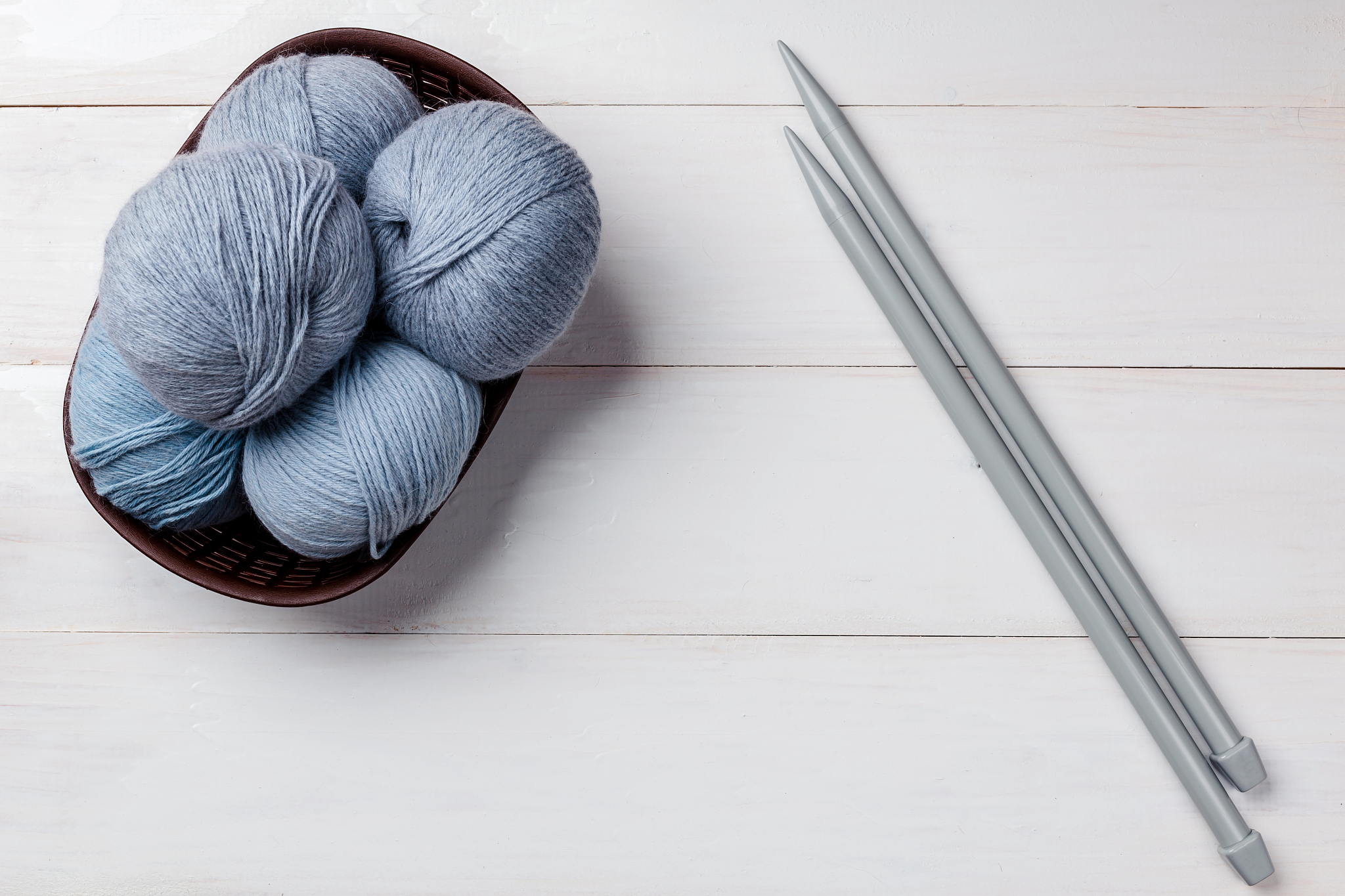 wool skeins of thread on white boards. a ball of thread from the