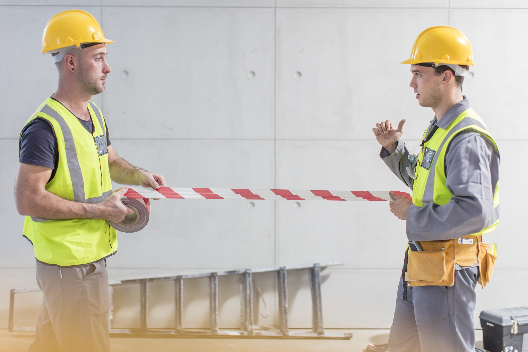 construction workers using tape on construction site