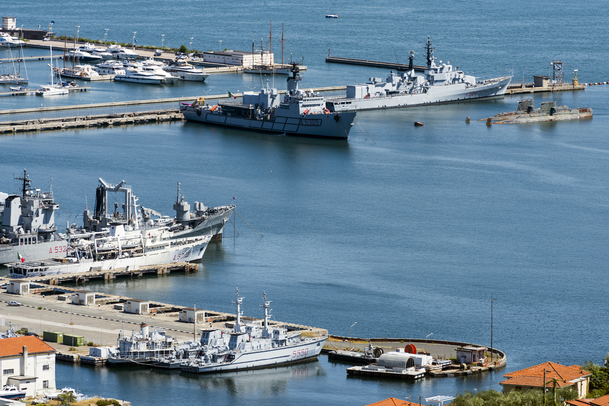 view of the military, commercial dock and ships with mountains o