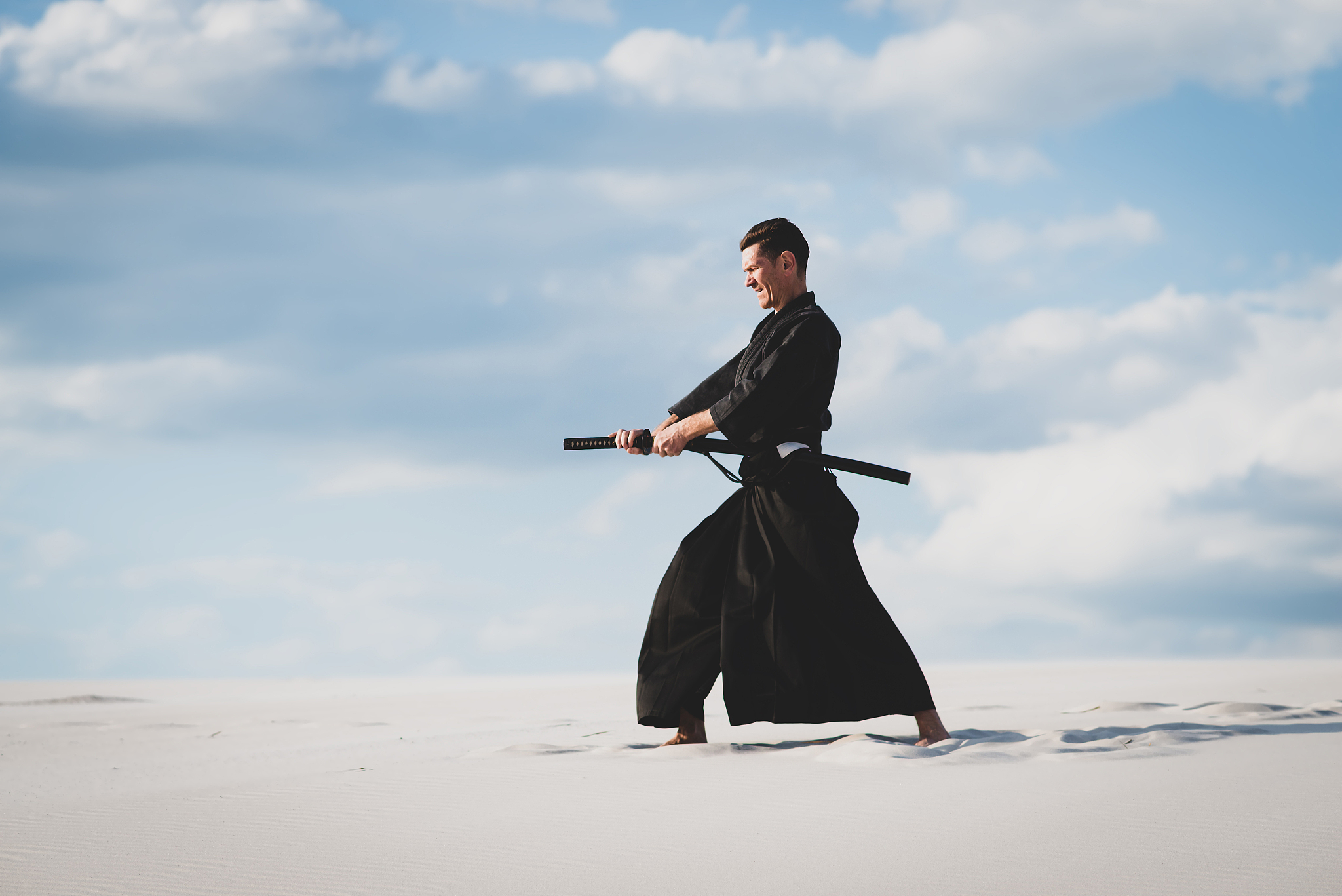 man training martial arts in desert