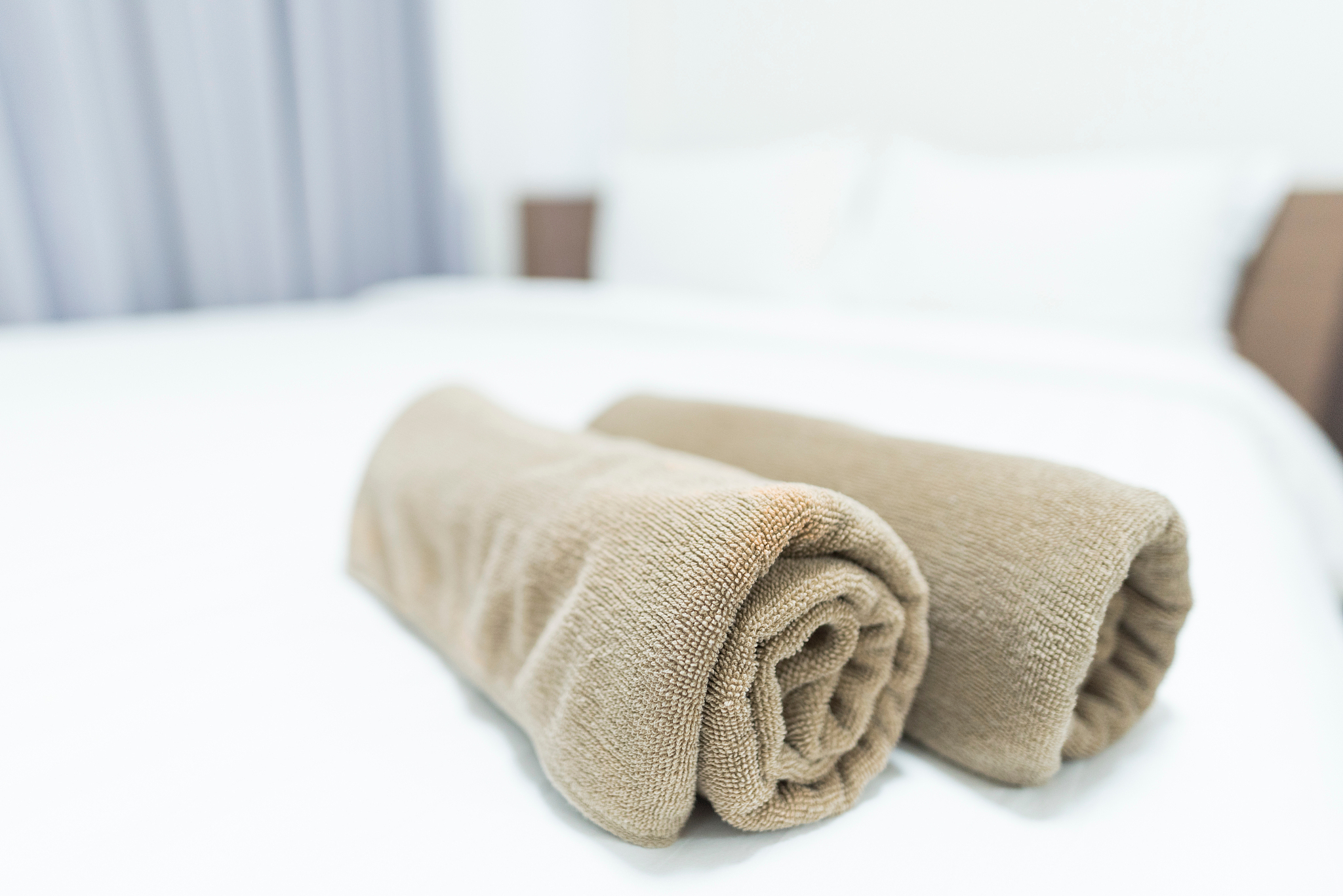 close-up of rolled towels on bed