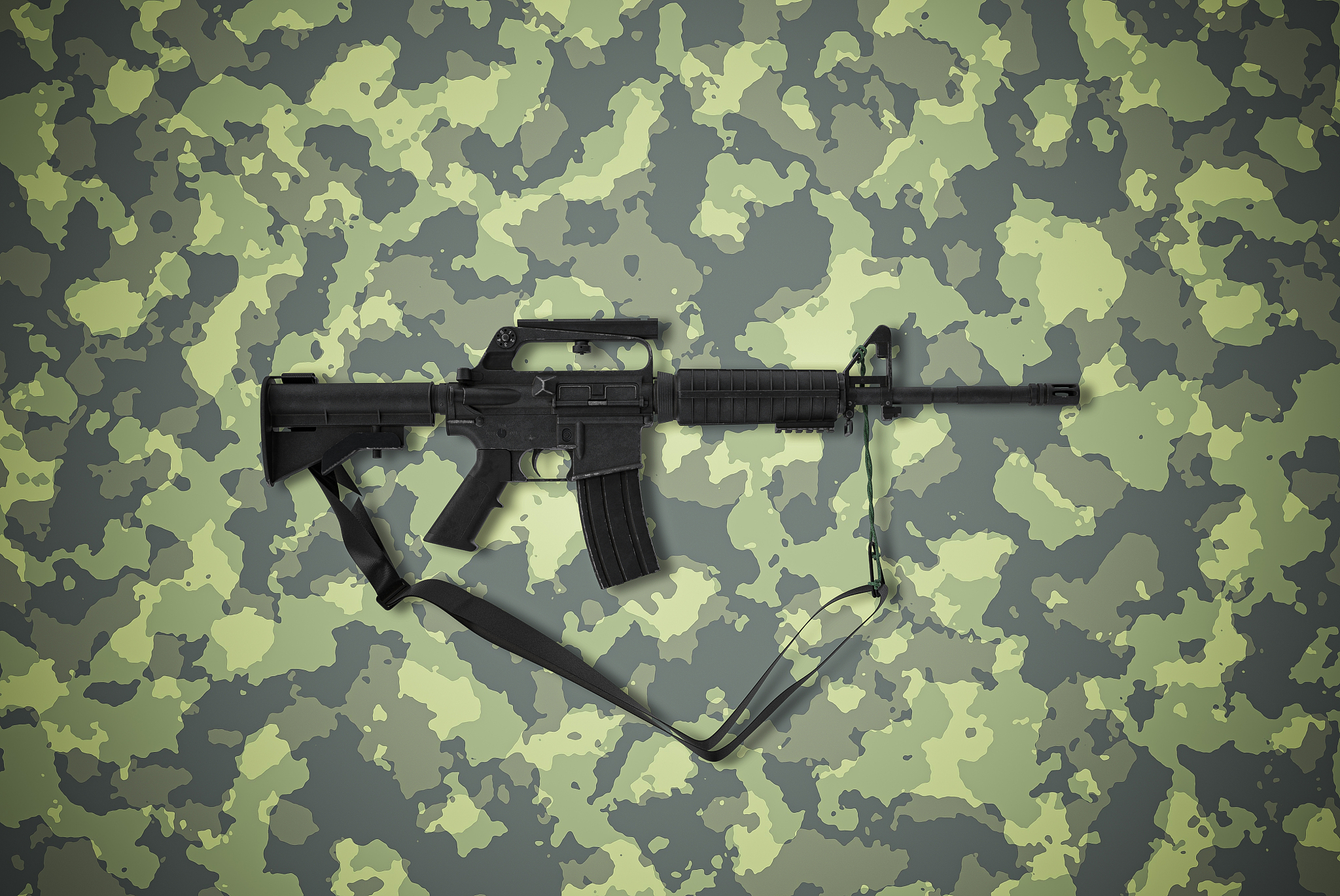 american caliber 5.56 mm rifle on camouflage background