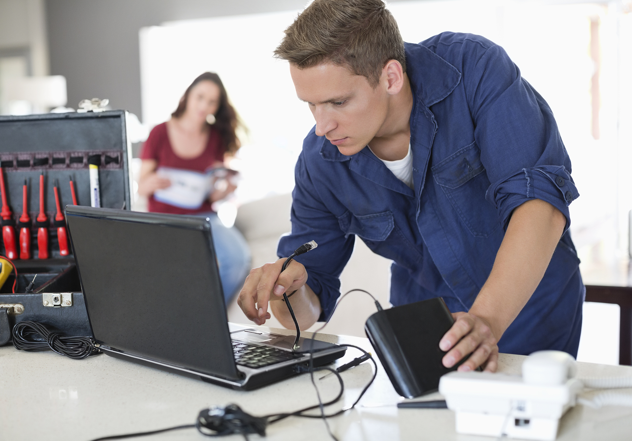 electrician using laptop in home