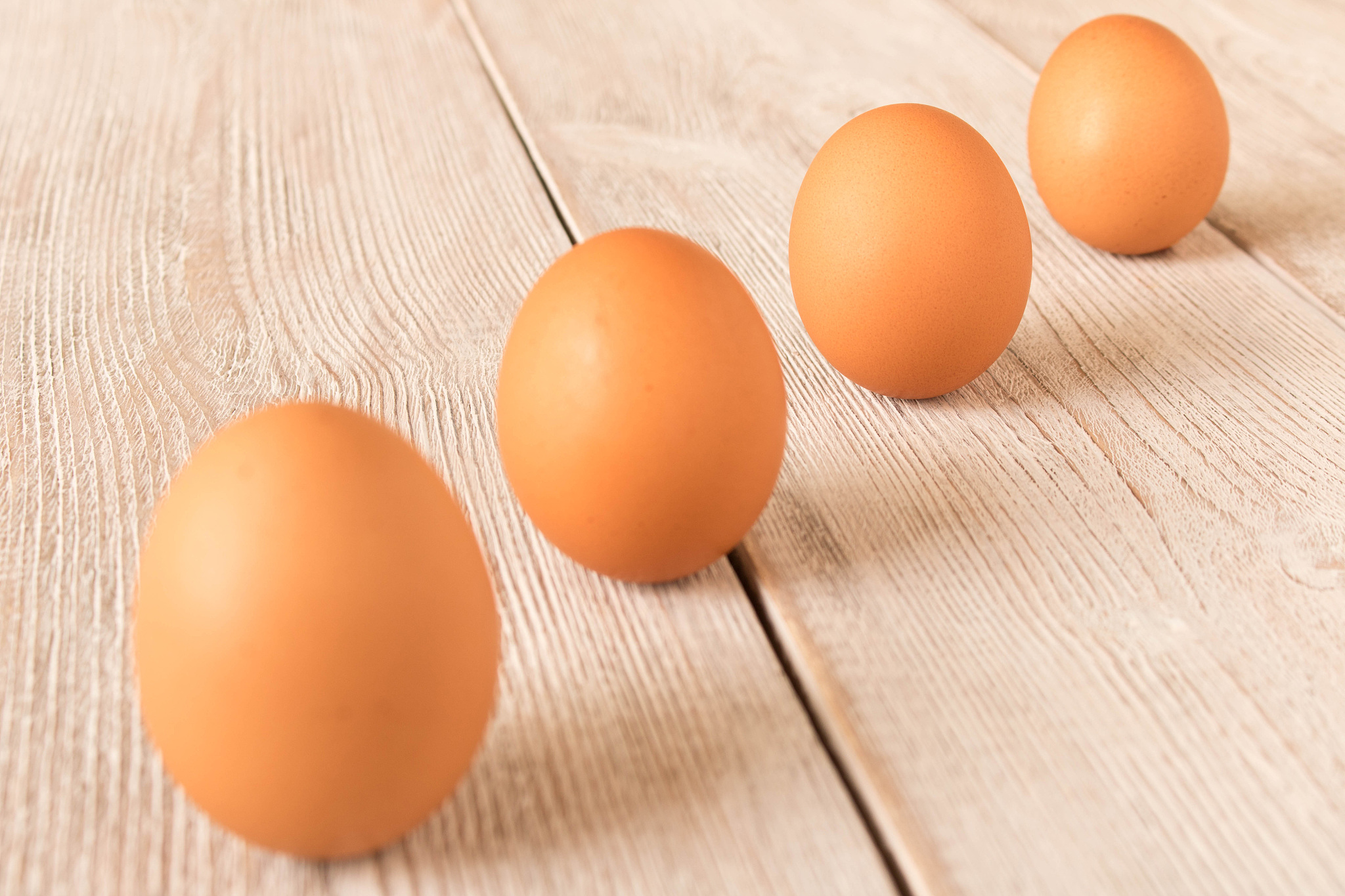 chicken eggs on a wooden table. selective focus.