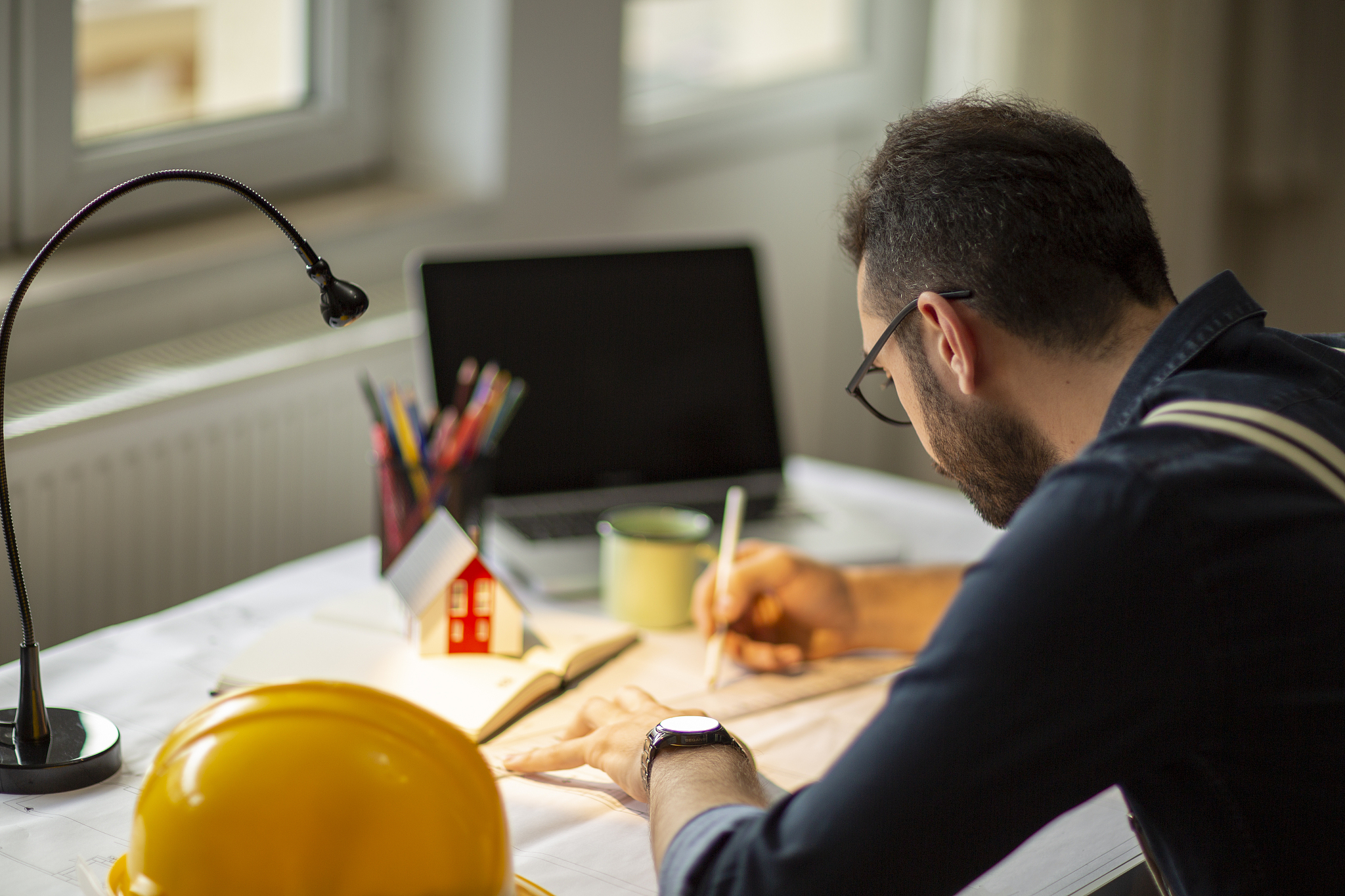 architect working with blueprints in the home office.