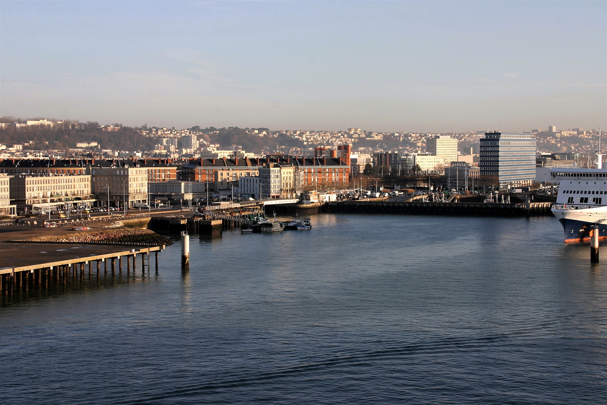 river by cityscape against clear sky