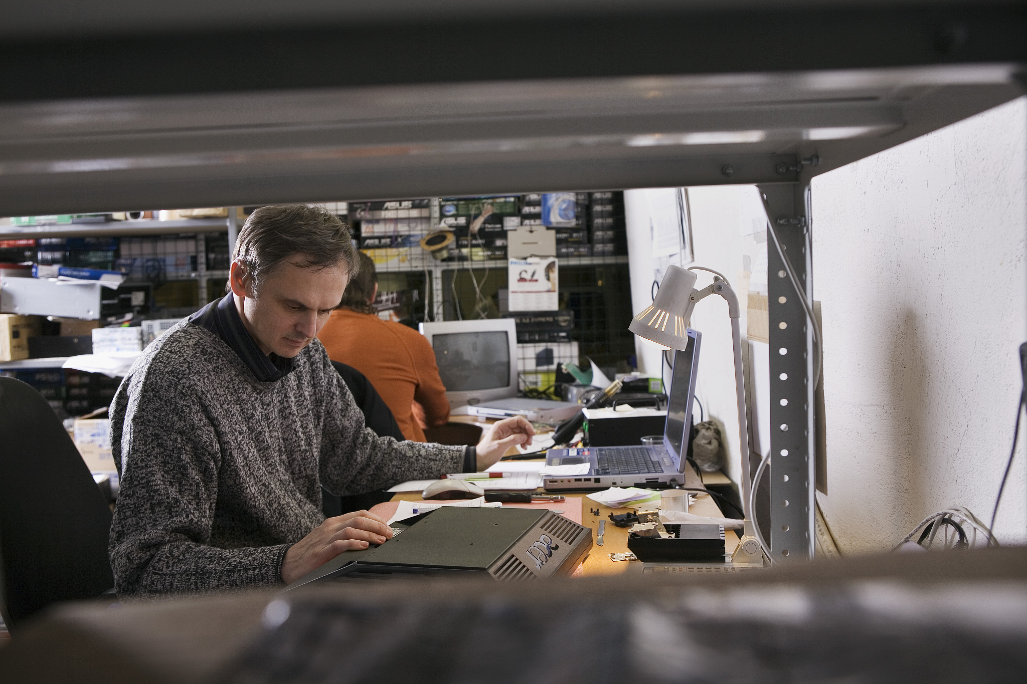 two workers at computer repair shop