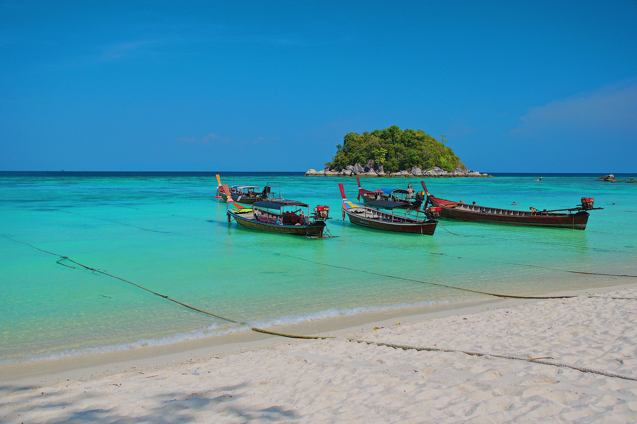 idyllic view of longtail boats moored on beach against sky at ko