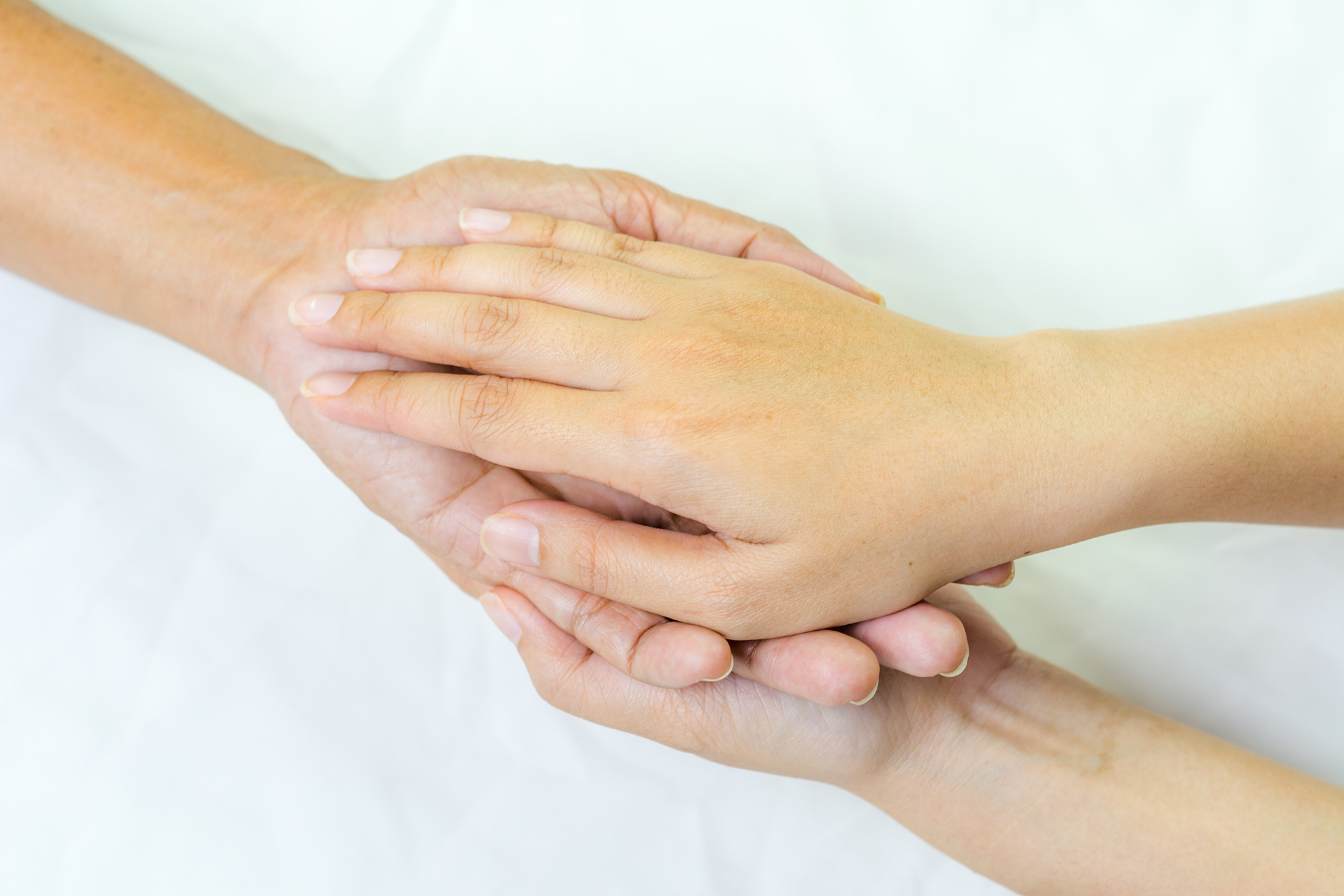 asian senior and asian young holding hands.