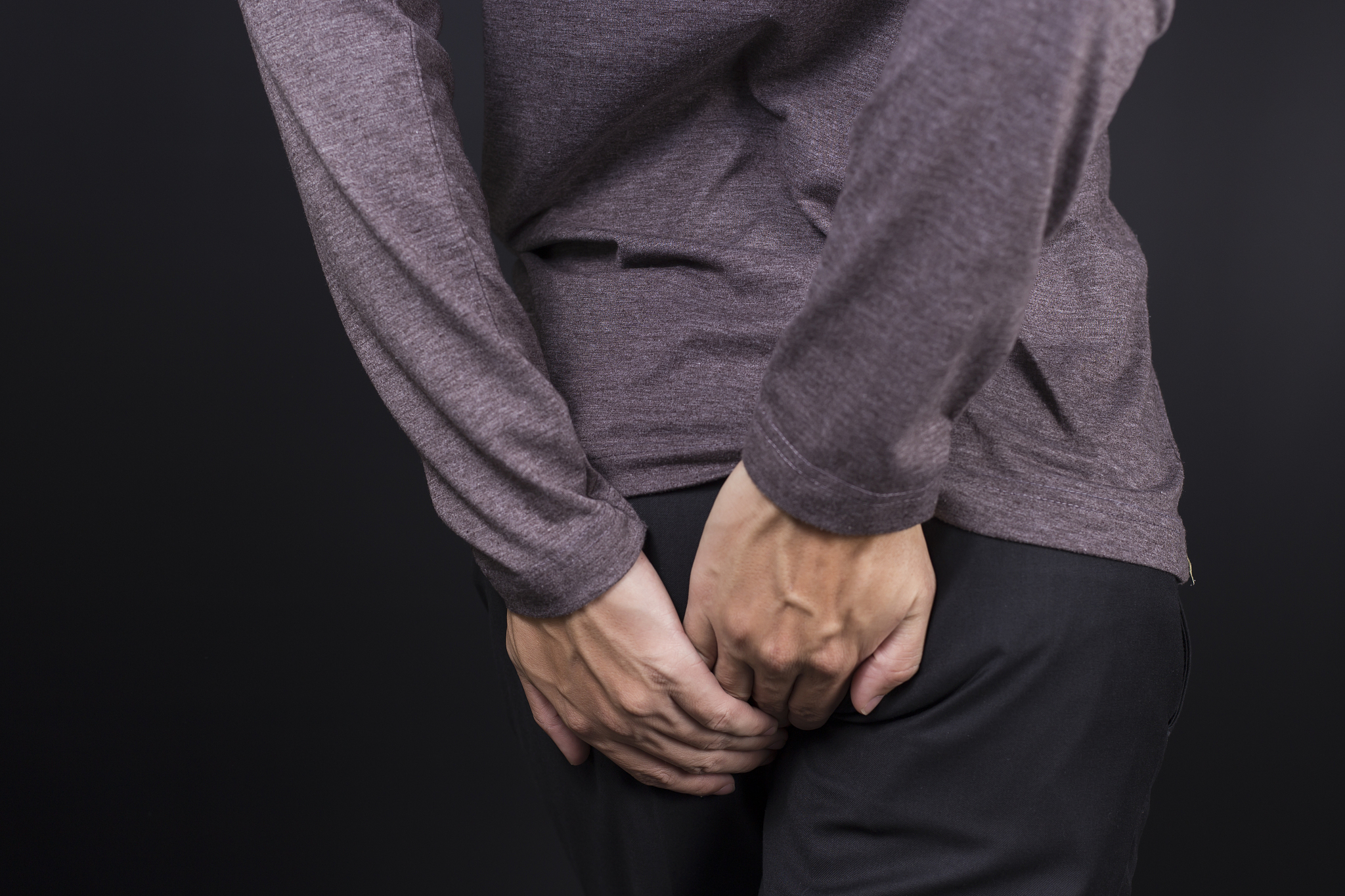 man has diarrhea holding his butt