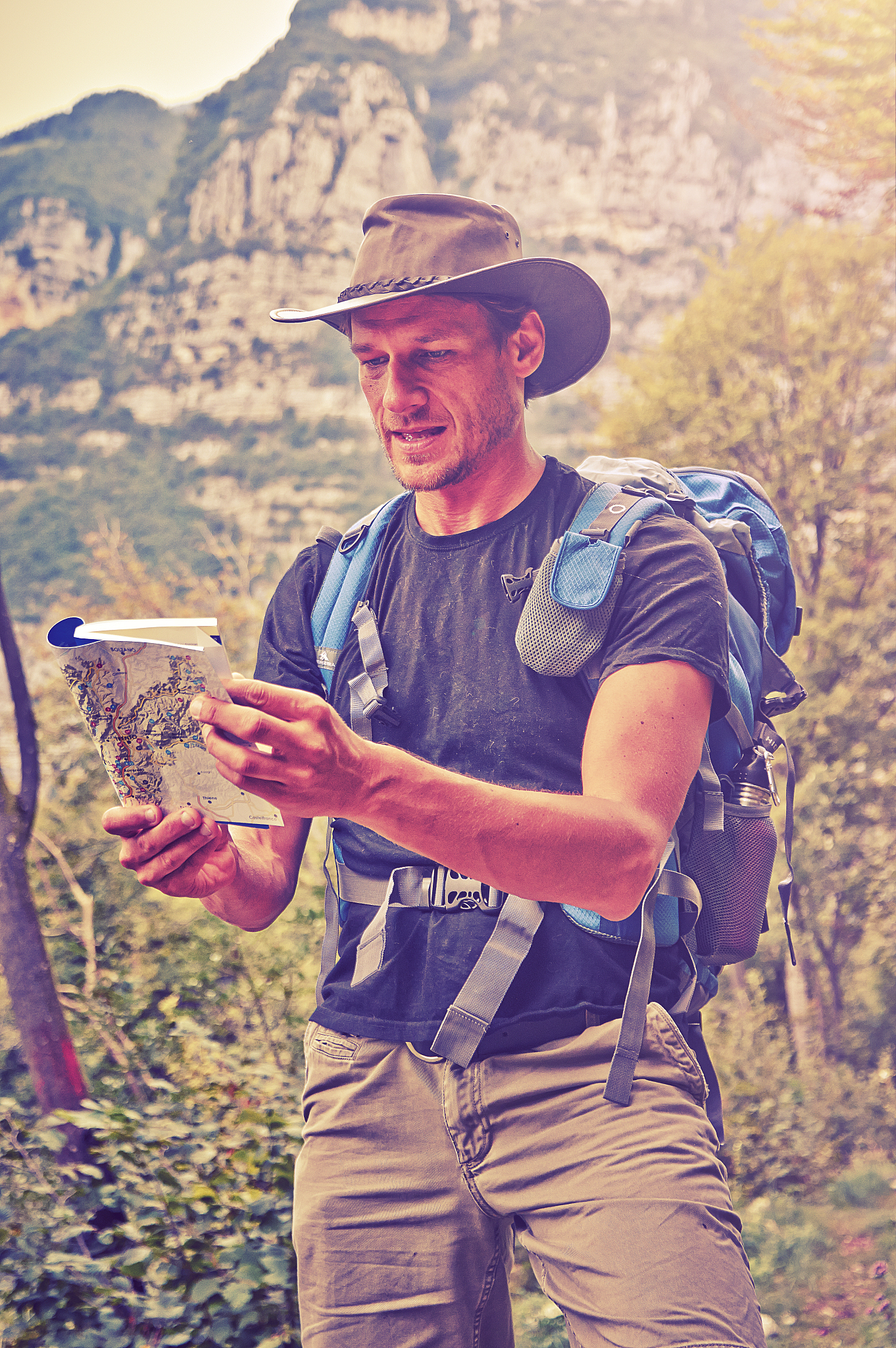 hiker/adventurer looking at map