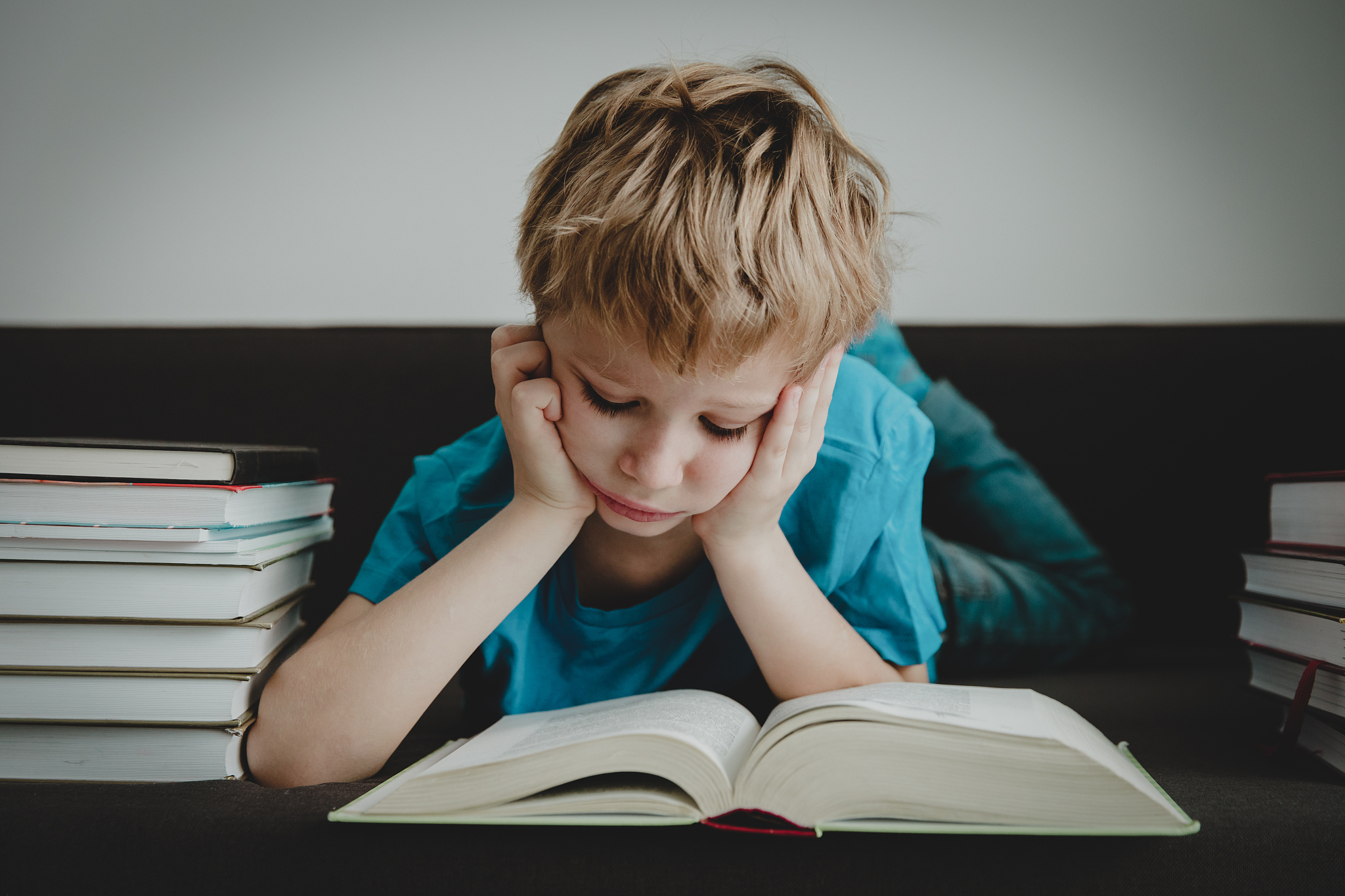 little boy bored tired stressed of reading books