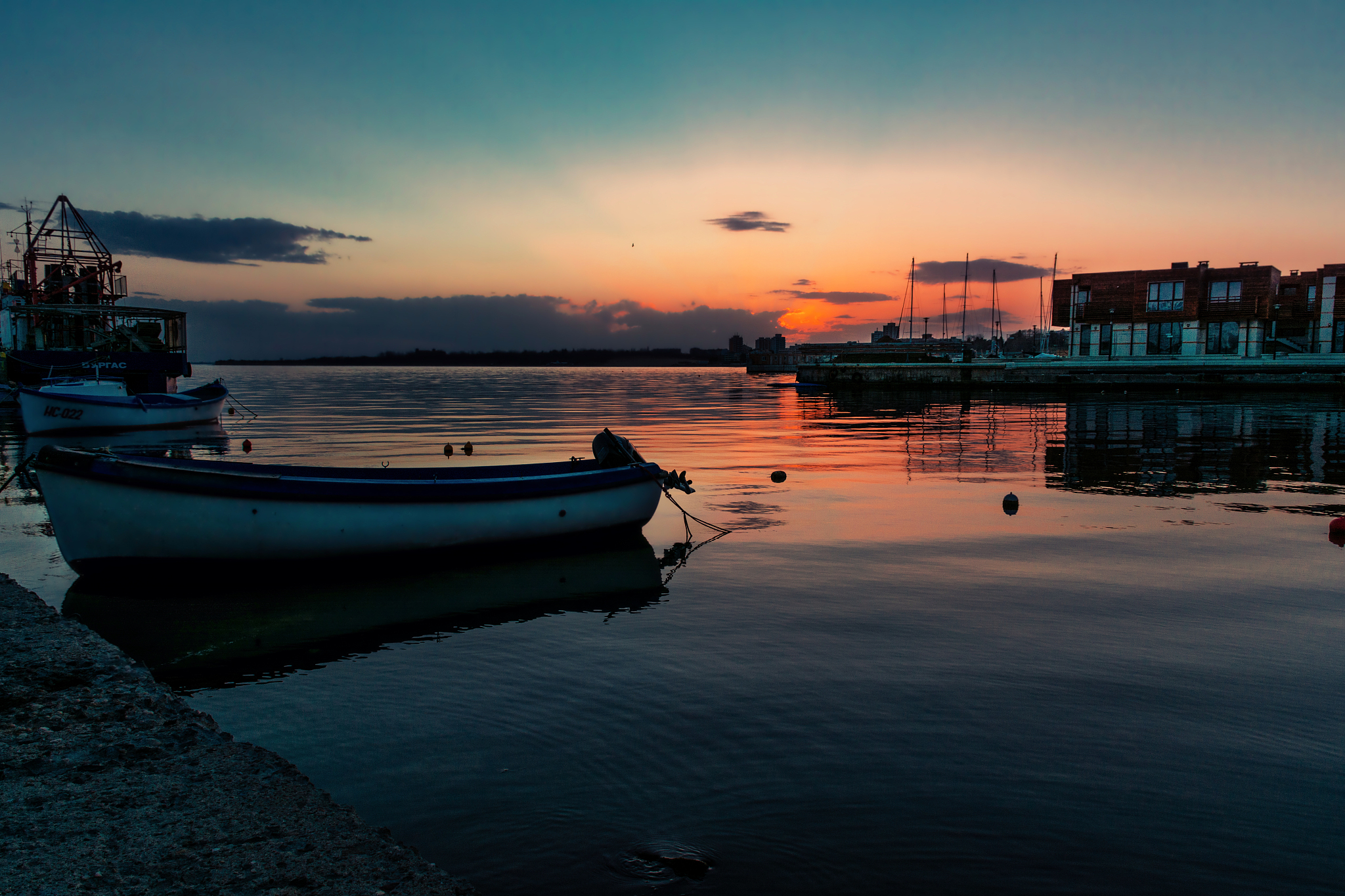 boats moored in sea against sky during sunset
