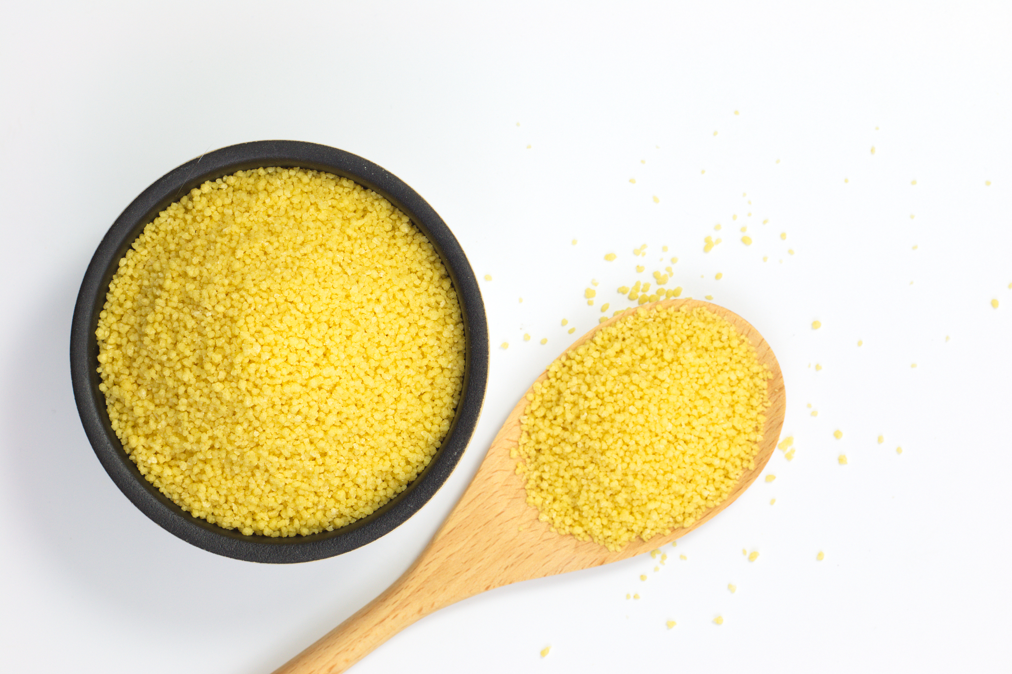 food concept raw organic couscous in bowl on white background wi