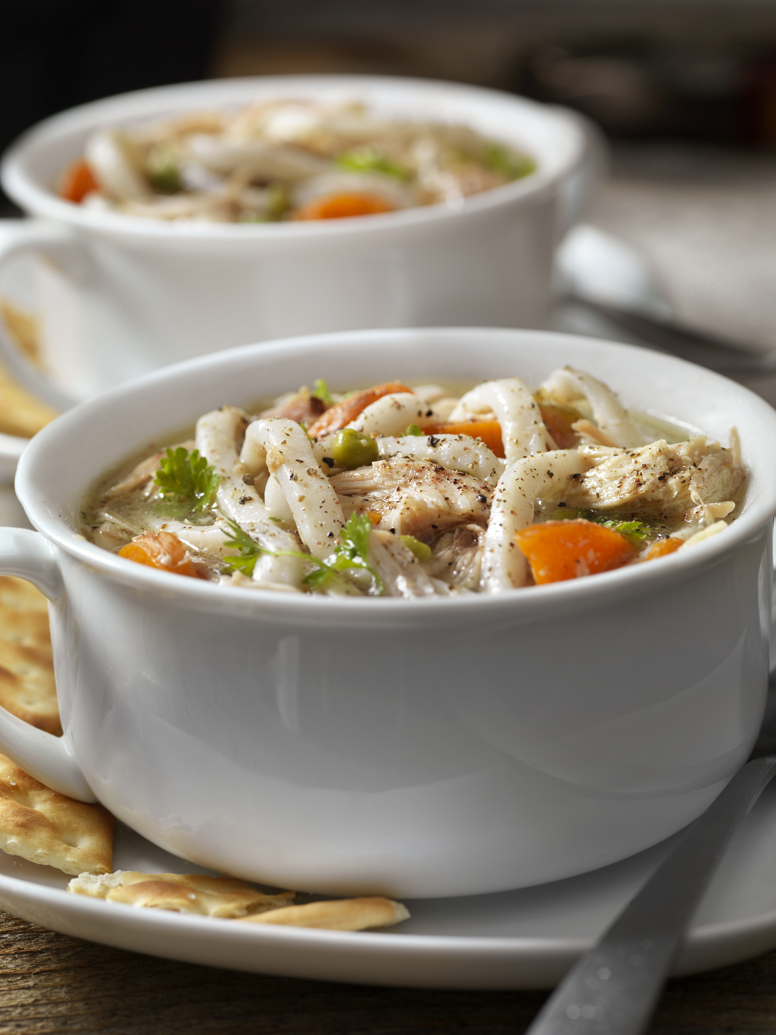 home made chicken soup with thick noodles and crackers