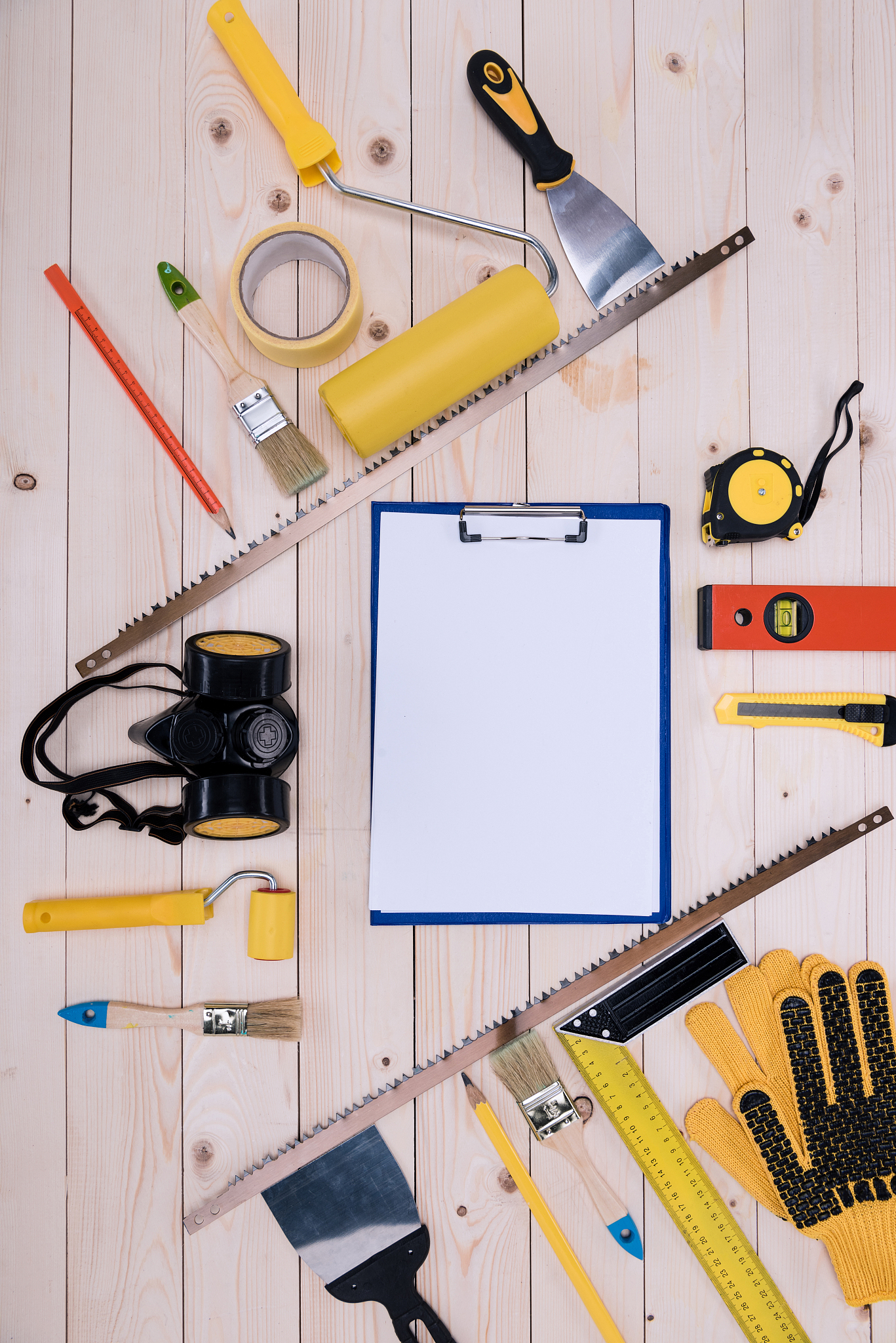 top view of set of construction tools and blank clipboard