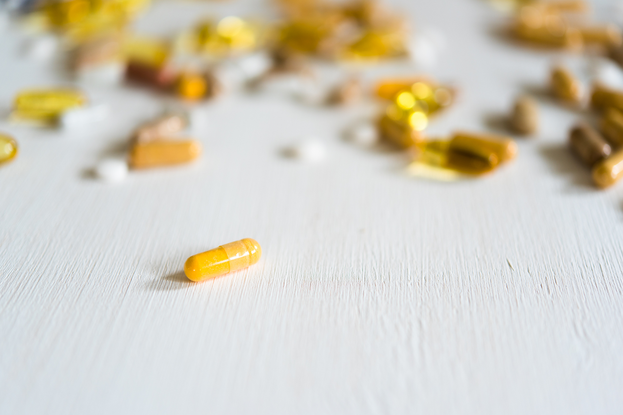 different pills on table with focus on one pill