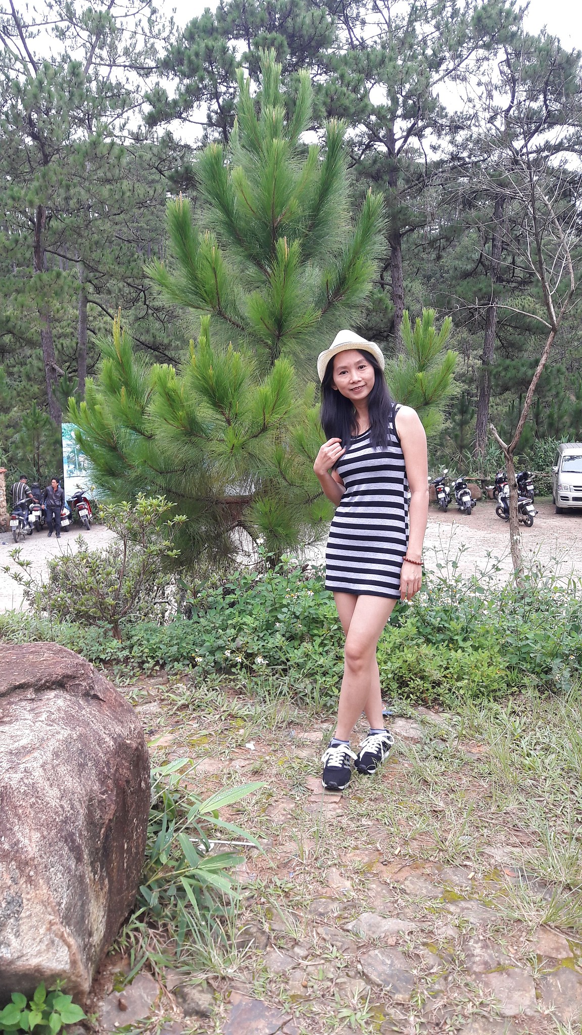 portrait of woman standing against tree
