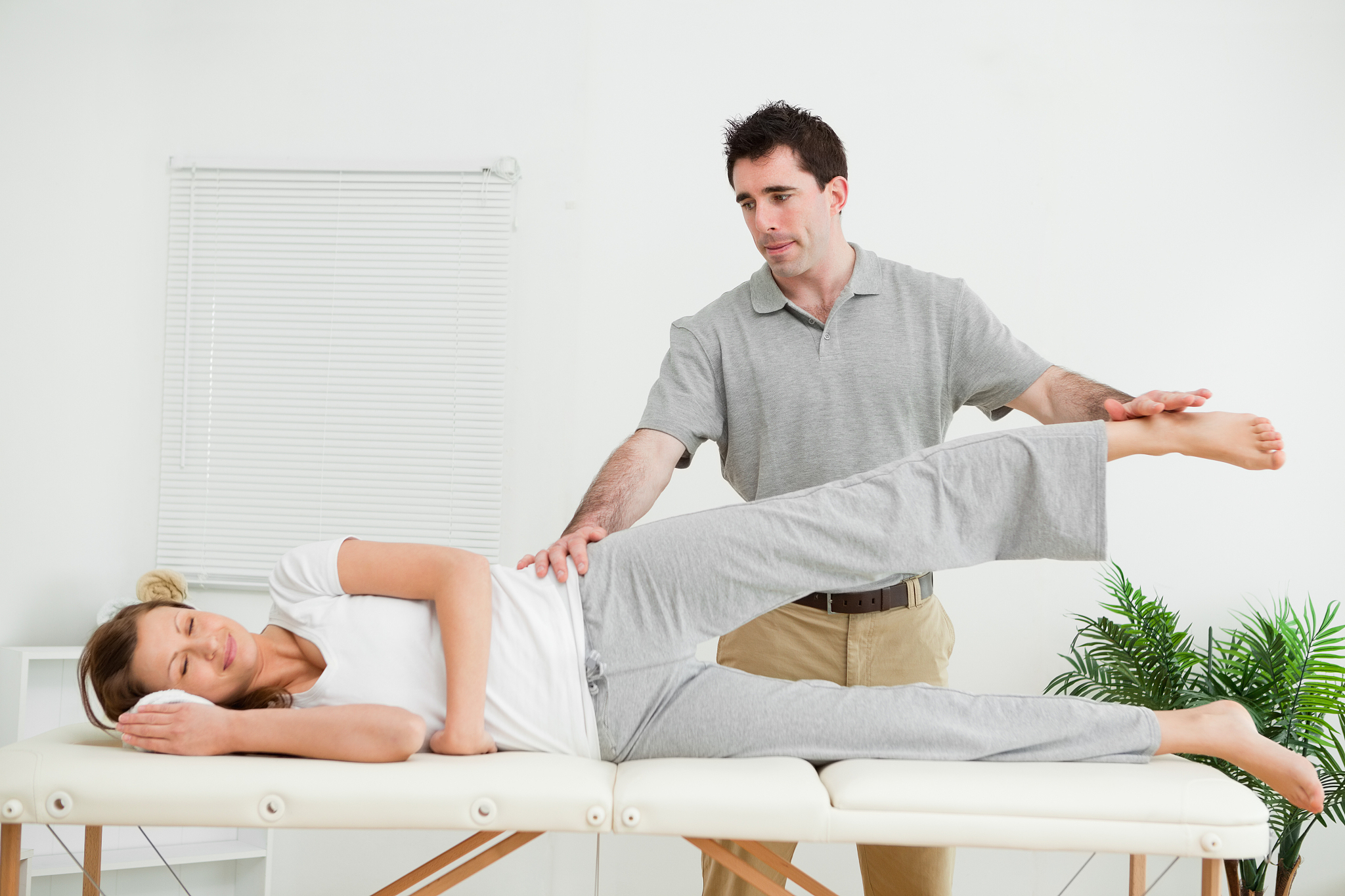 physical therapist checking the pelvis of a woman