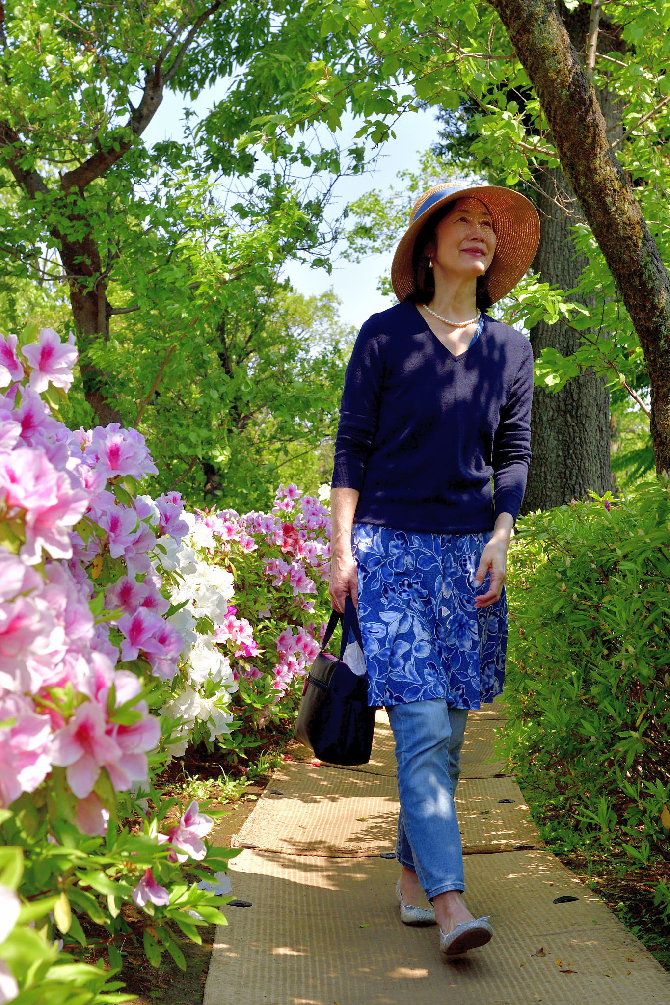 japanese woman enjoying walking in tokyo public park with azalea