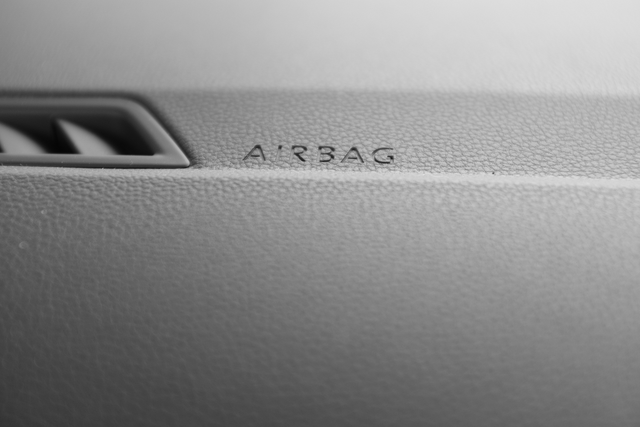 close-up of a sign on the dashboard of a car indicating the loca