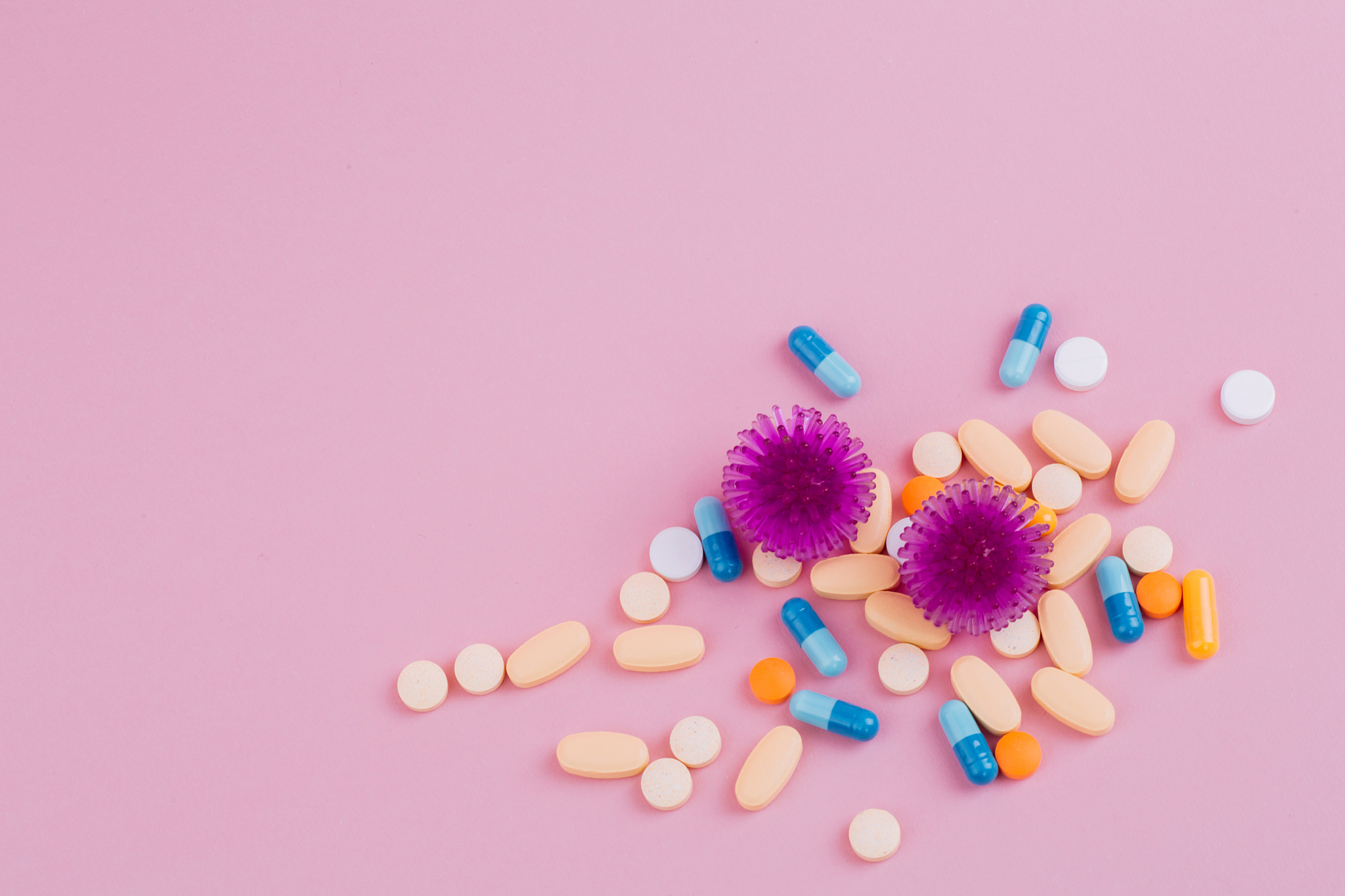 violet virus and a diverse pill on a pink background, the risk o