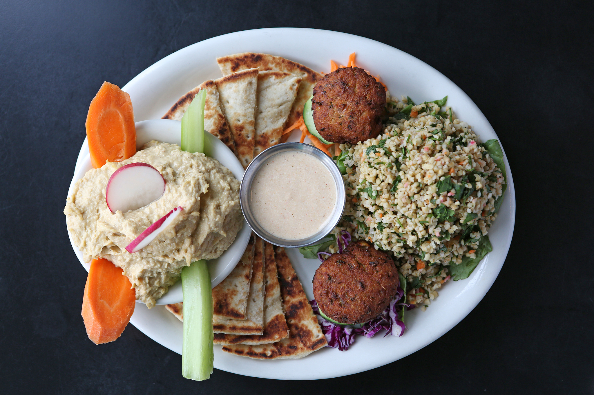 assortment of falafel, pita bread, hummus and tabbouleh