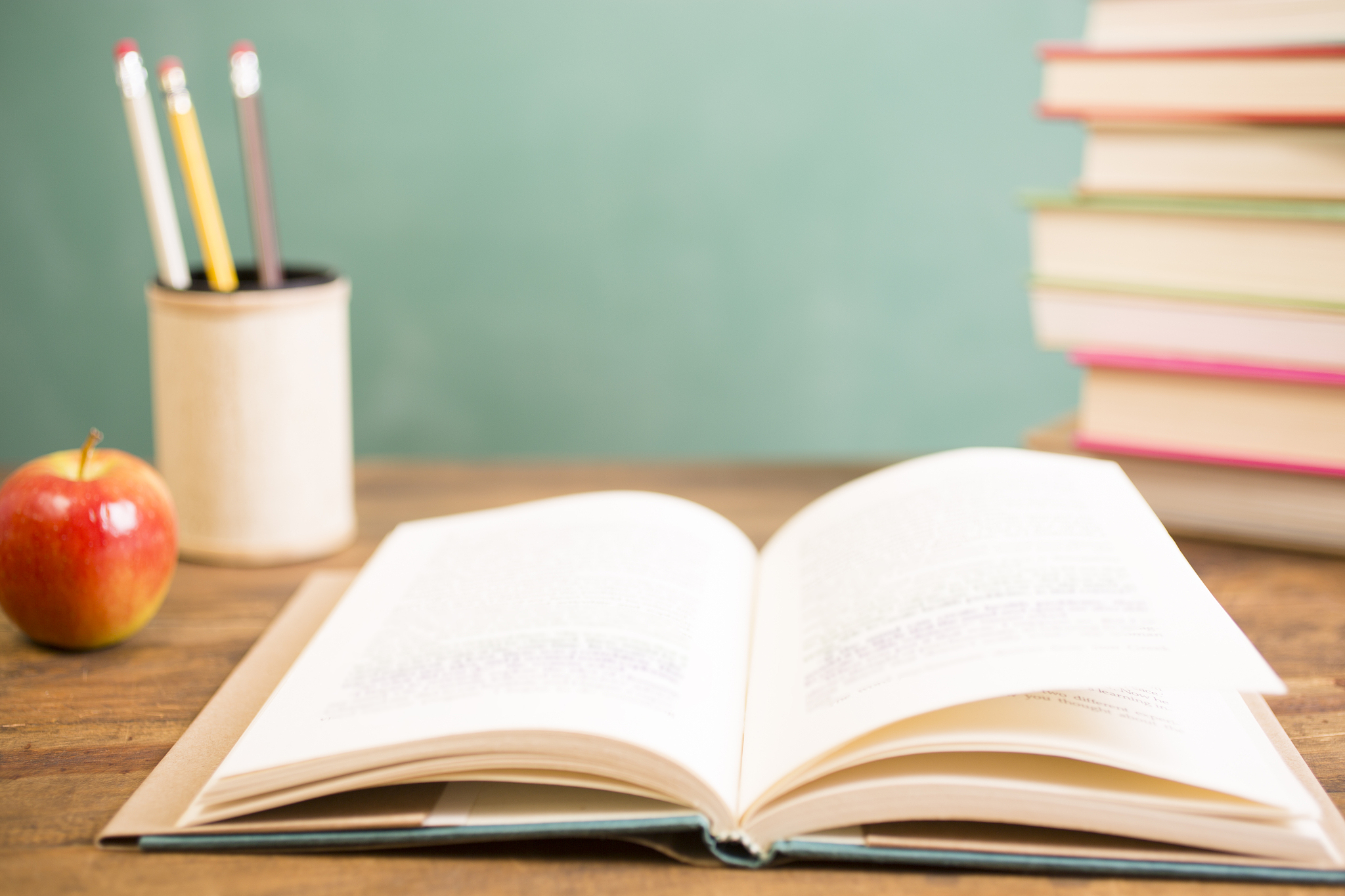 back to school. education. textbooks on desk. chalkboard.