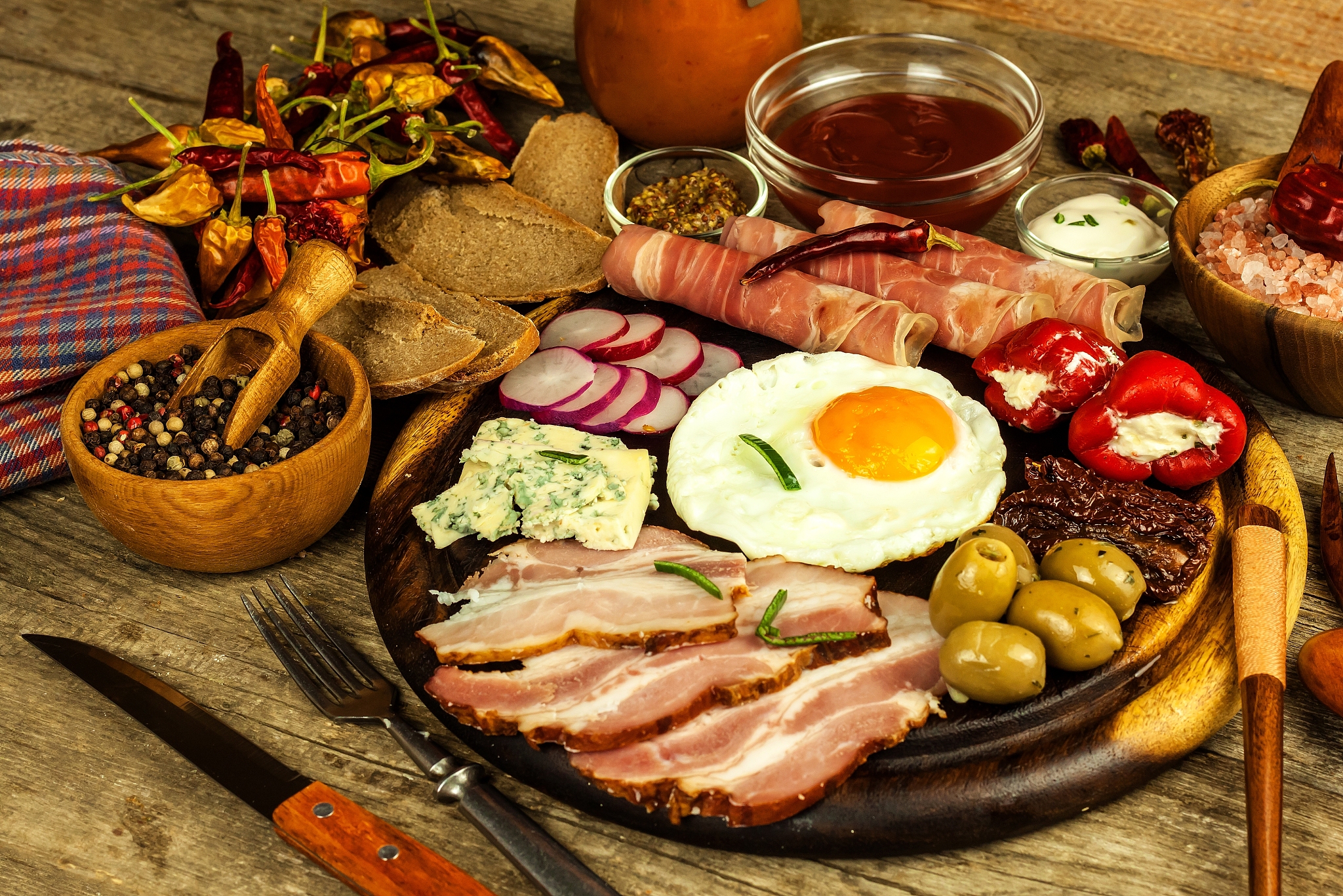 fried egg on a wooden board. a hearty breakfast with ham and veg