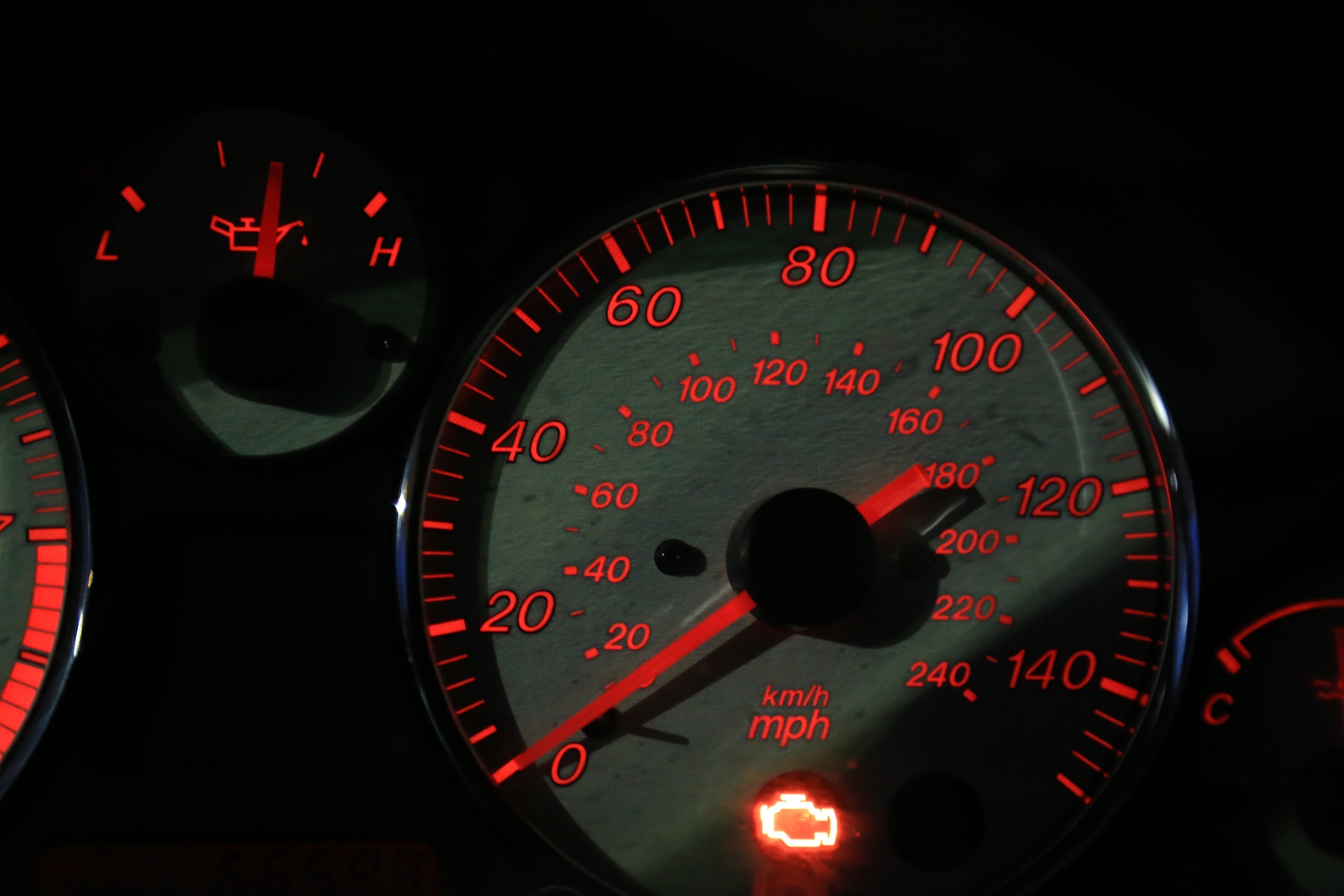 illuminated check engine light displayed on a vehicle