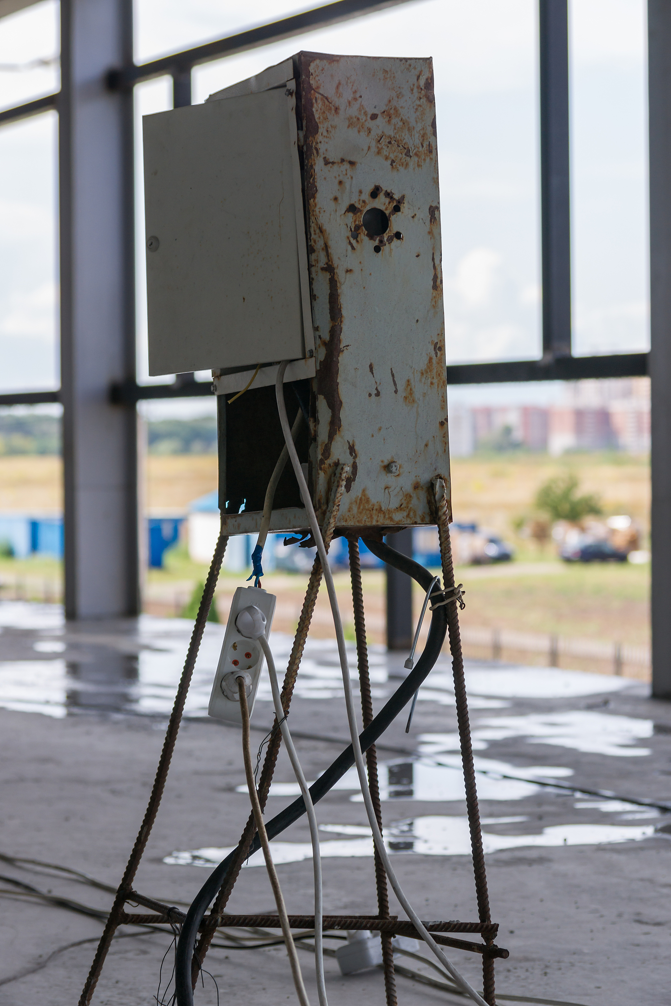 bad metal electric switchboard on an unfinished construction sit