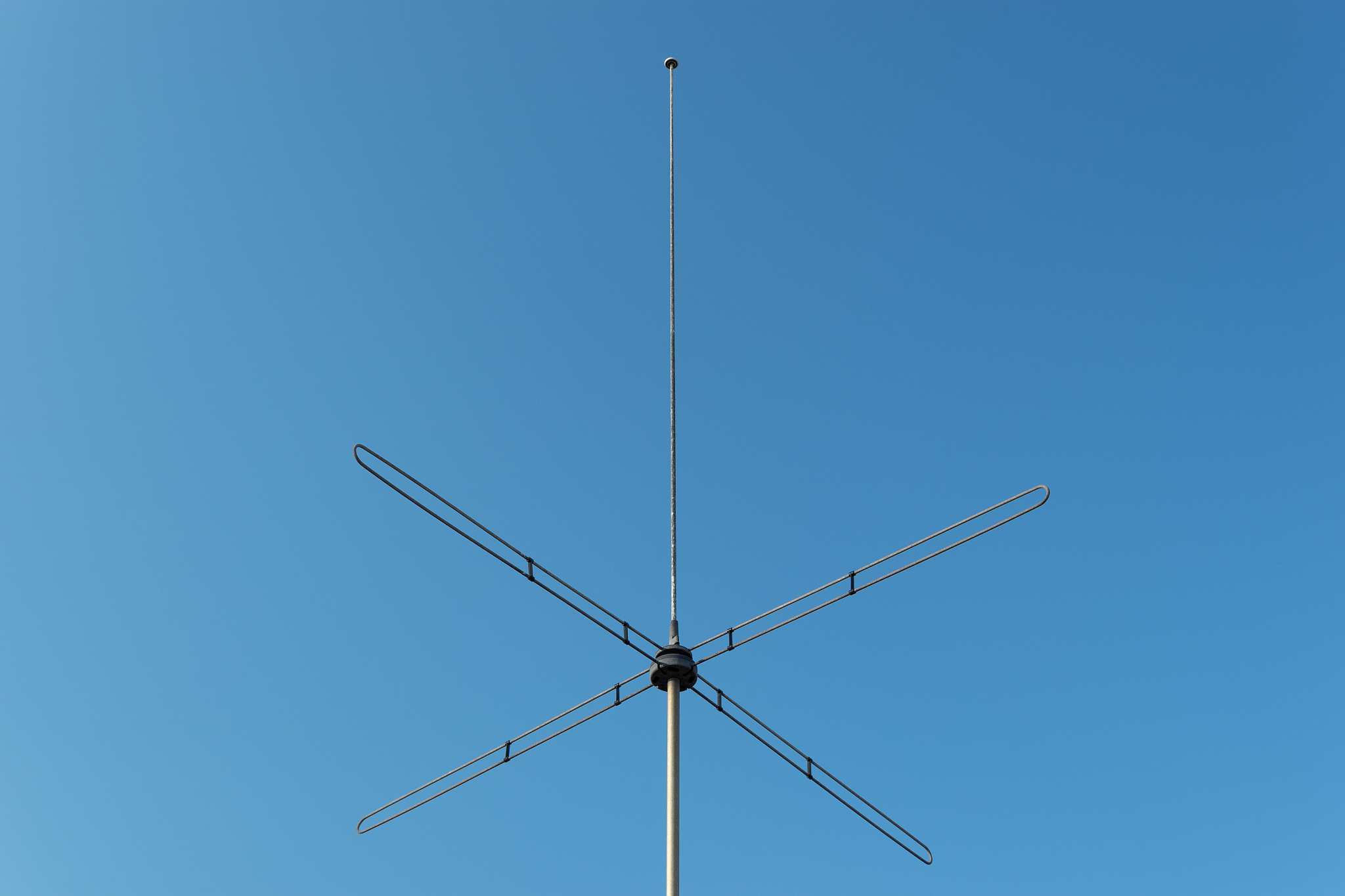 low angle view of antenna against clear blue sky