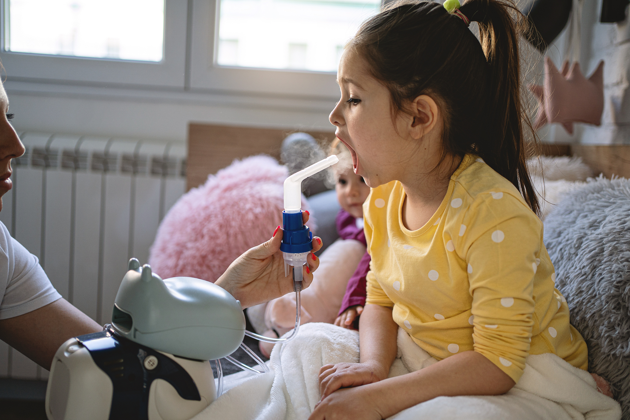 little girl inhaling at home