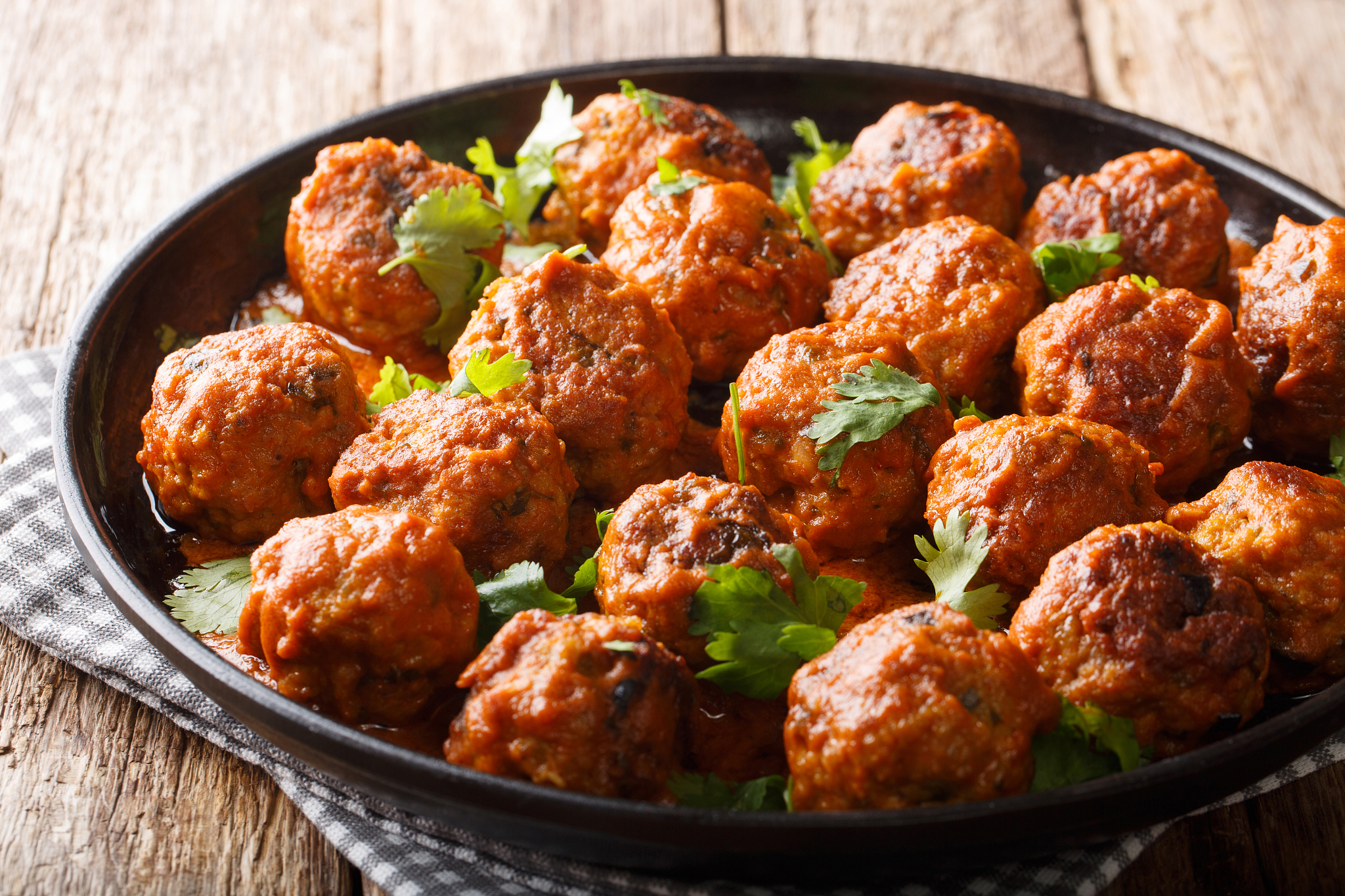 spicy chicken meatballs in coconut sauce with red curry closeup 