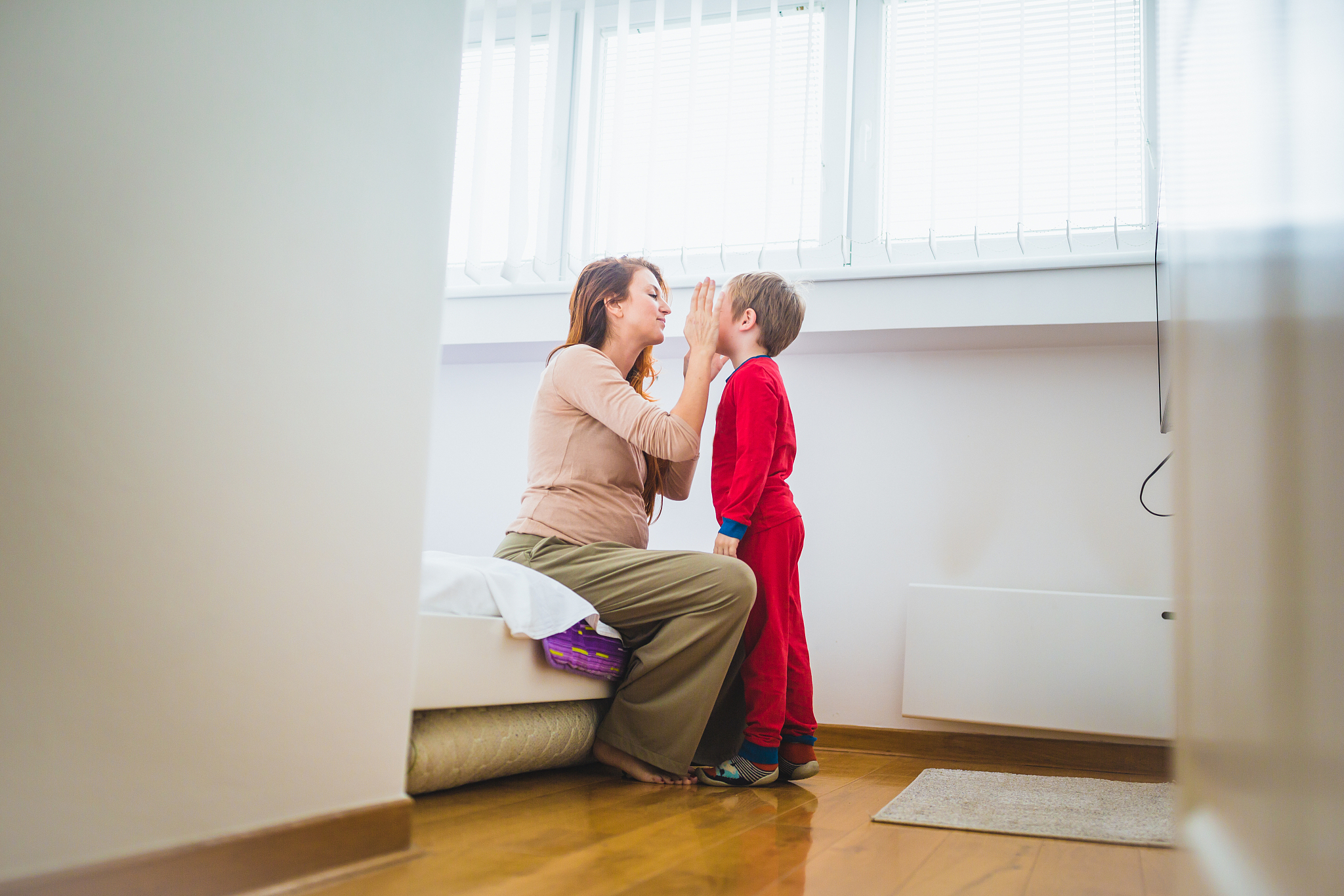 mother dressing son for school