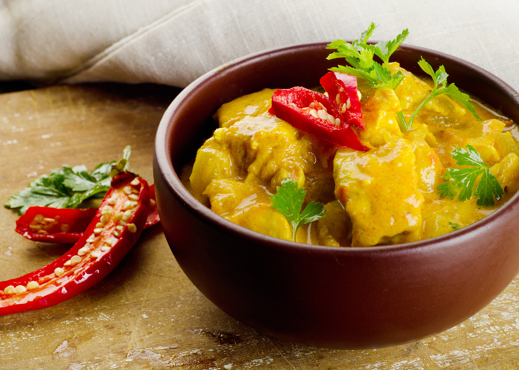indian chicken curry with parsley in bowl