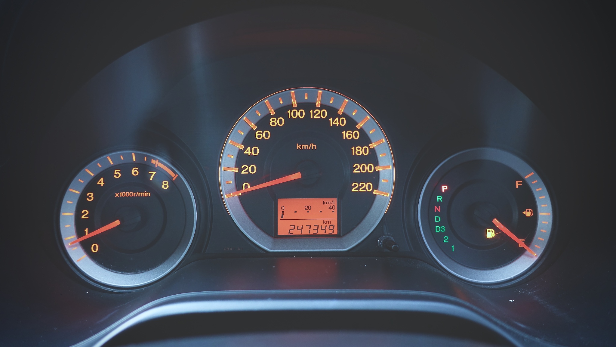 odometer speed in car with orange light showing about gas sign w