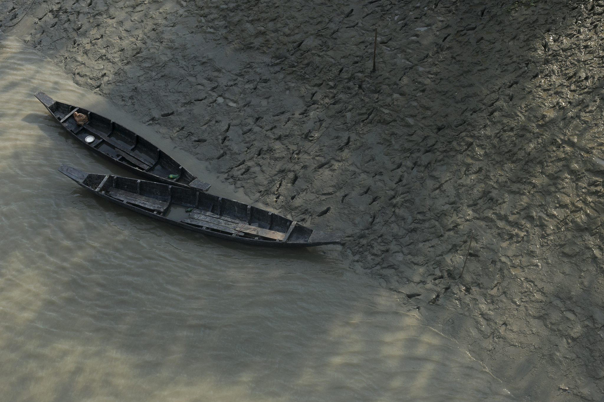 two wooden rowboats on beach