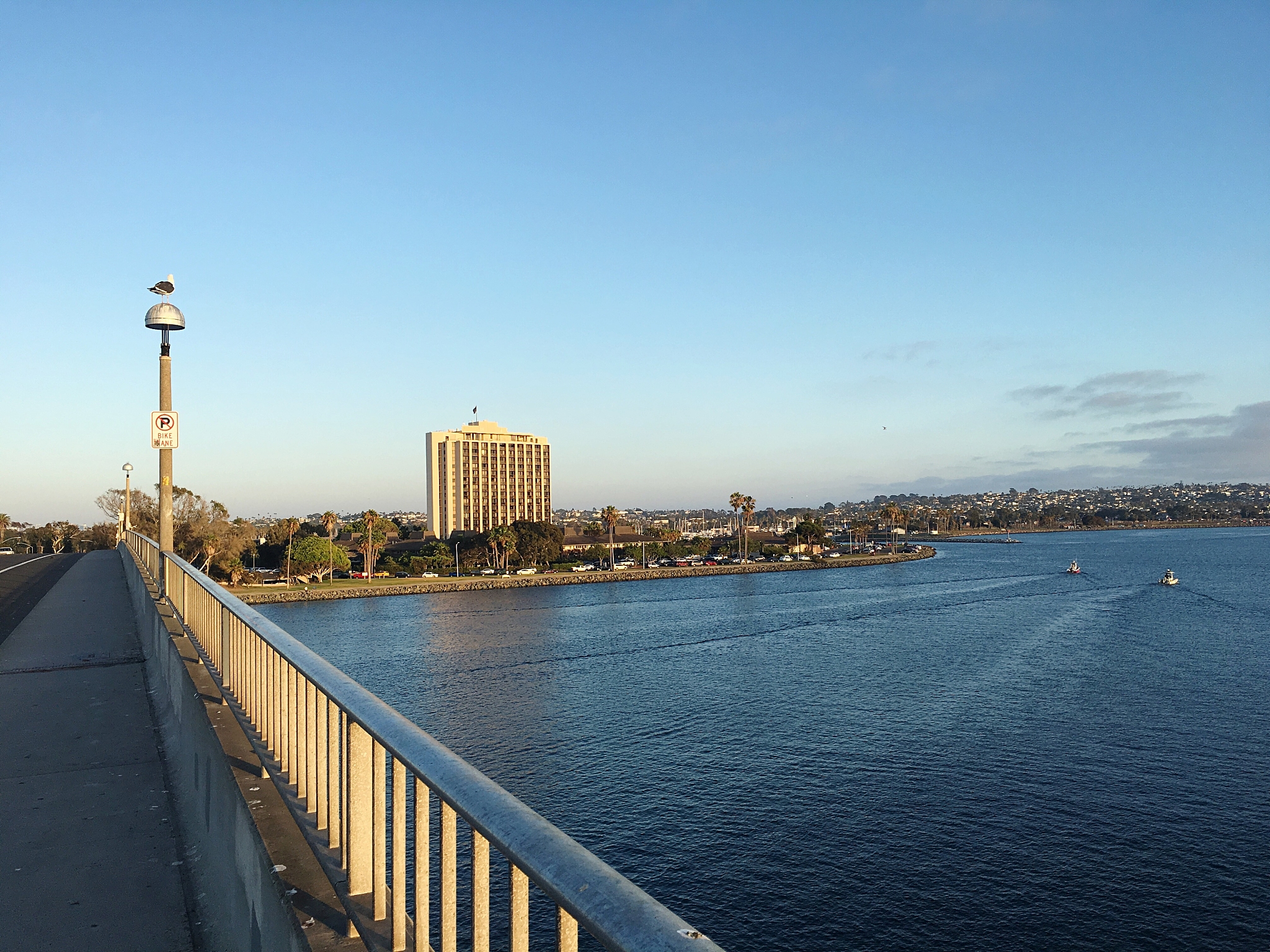 view of buildings by river against blue sky