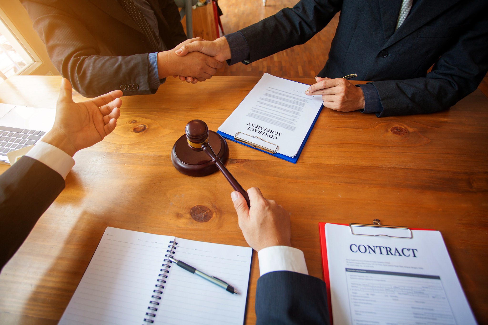 group of business people and lawyers discussing contract papers 