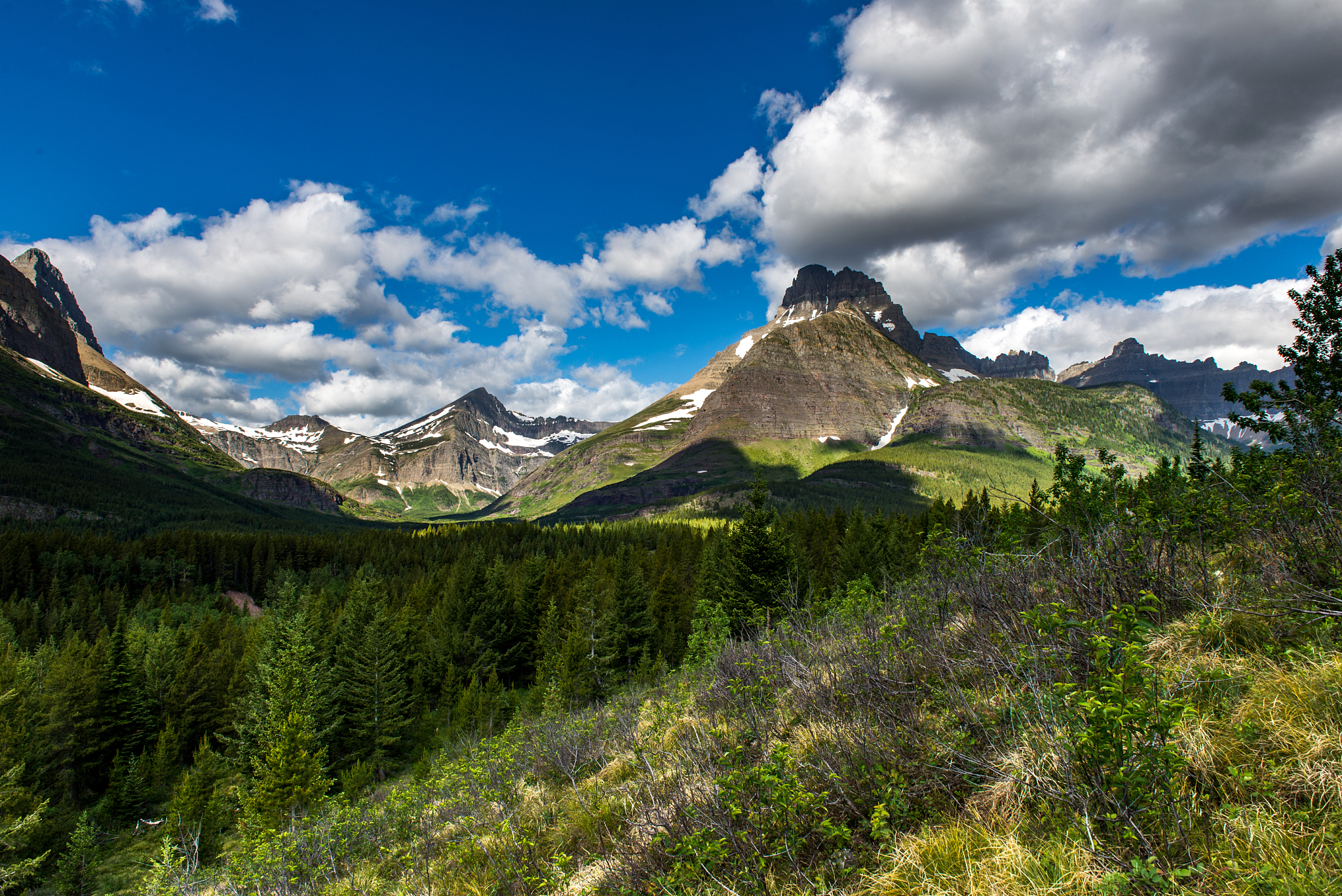scenic view of mountains against cloudy sky