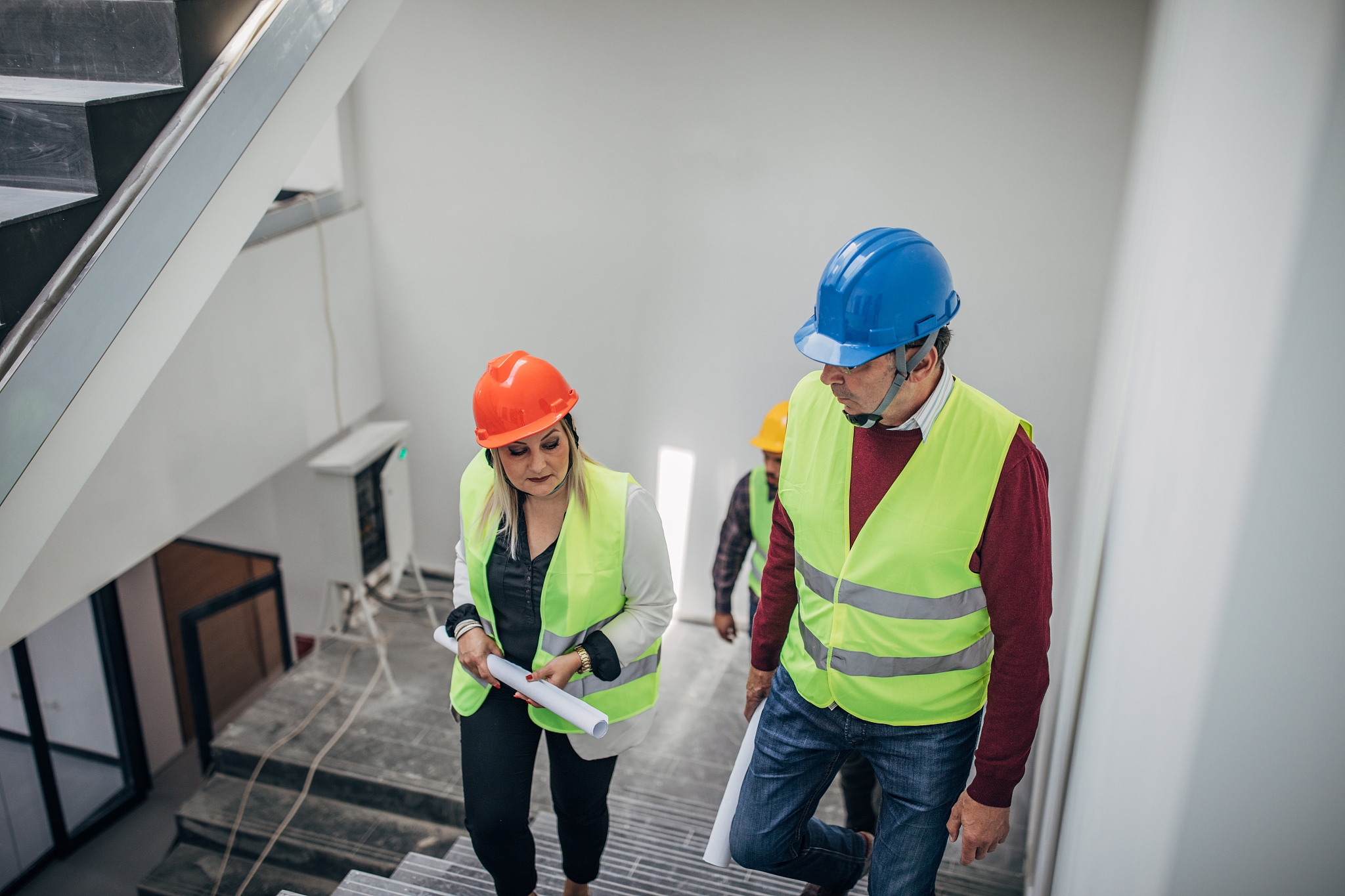 architects walking at construction site indoors
