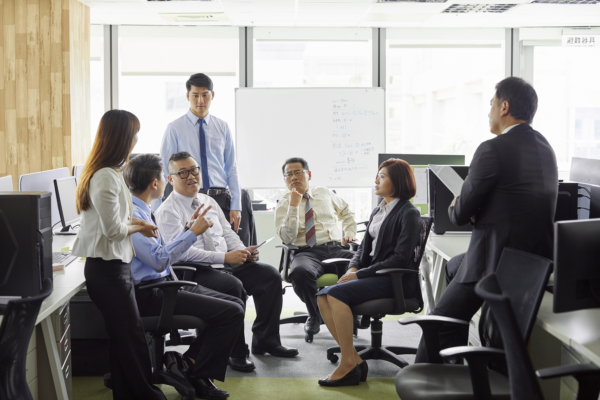 business coworkers discussing in office meeting