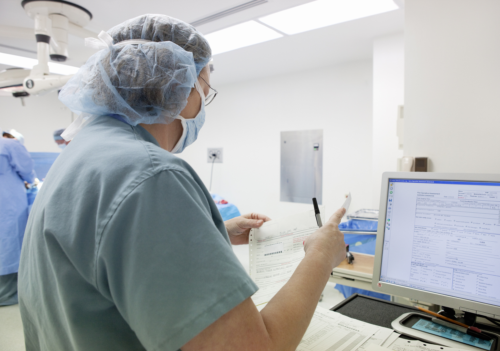 nurse documenting patient's surgical information