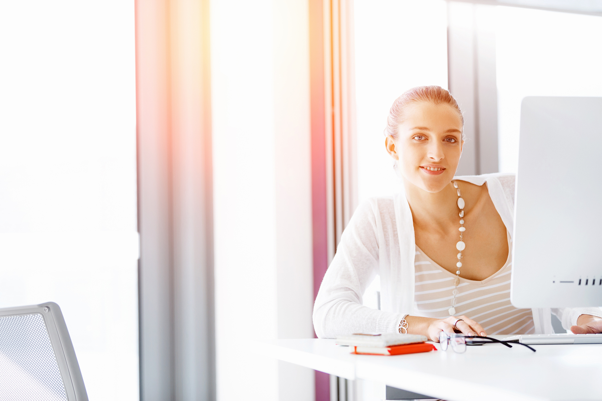 attractive office worker sitting at desk. attractive woman sitti