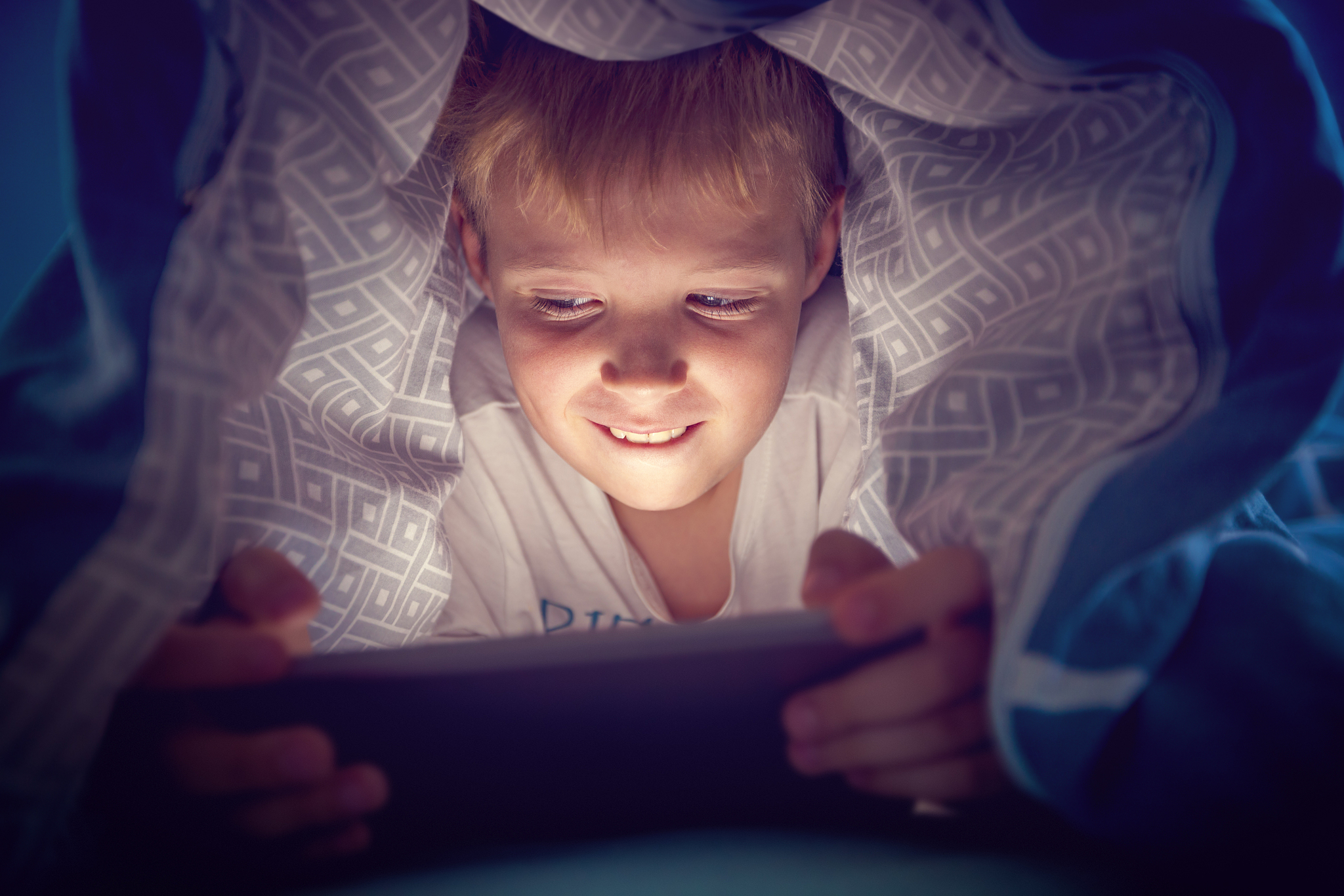 boy watching a movie on a digital tablet
