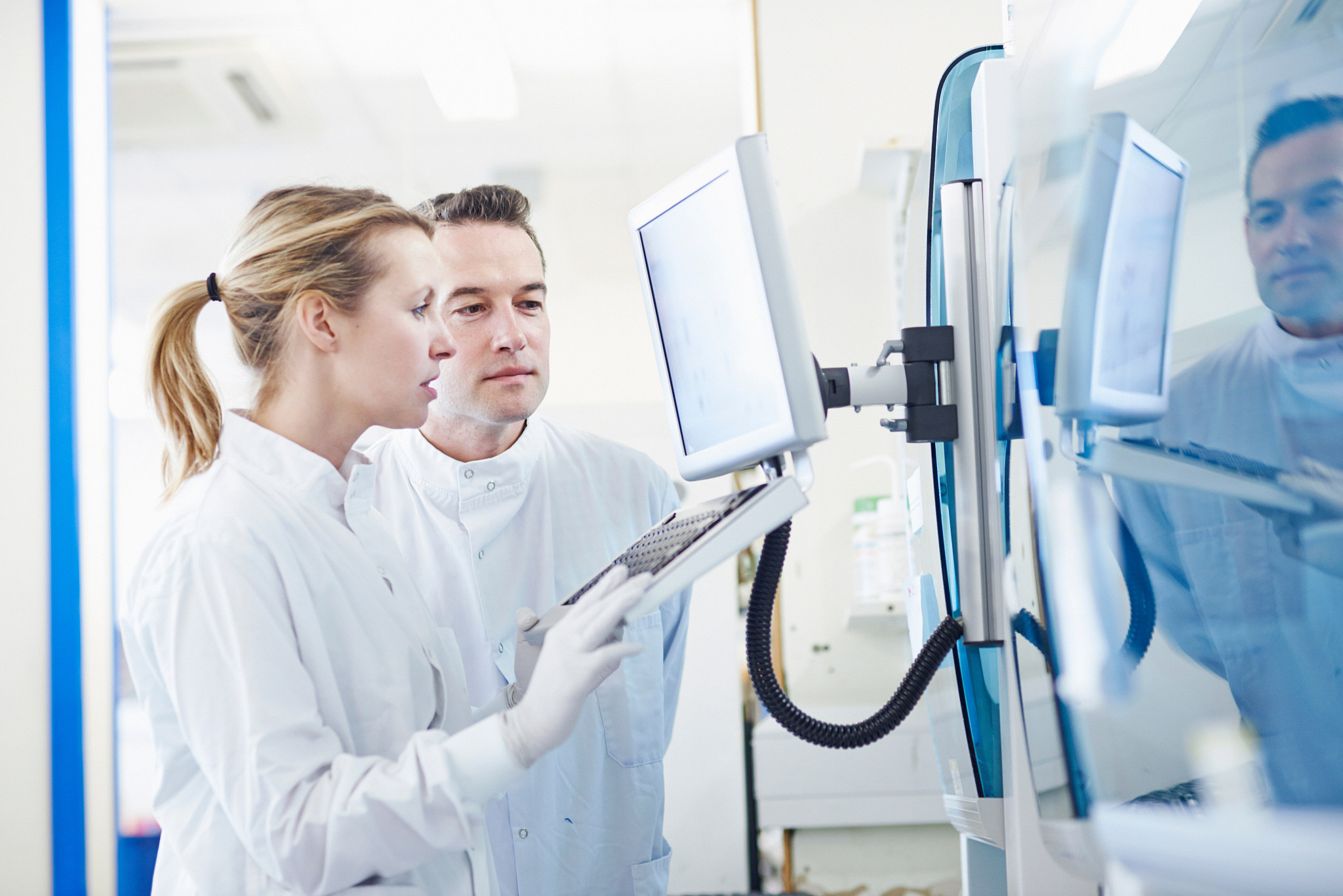 researchers looking at computer in lab